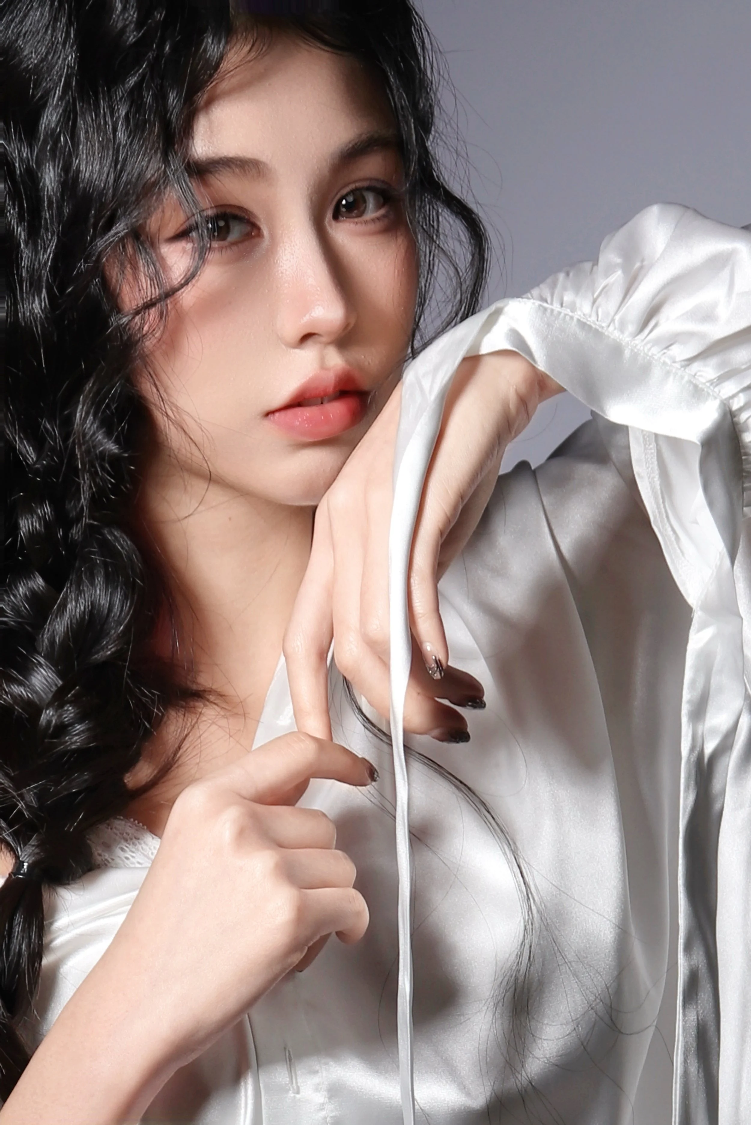 Close-up portrait of a woman with soft lighting and neutral expression