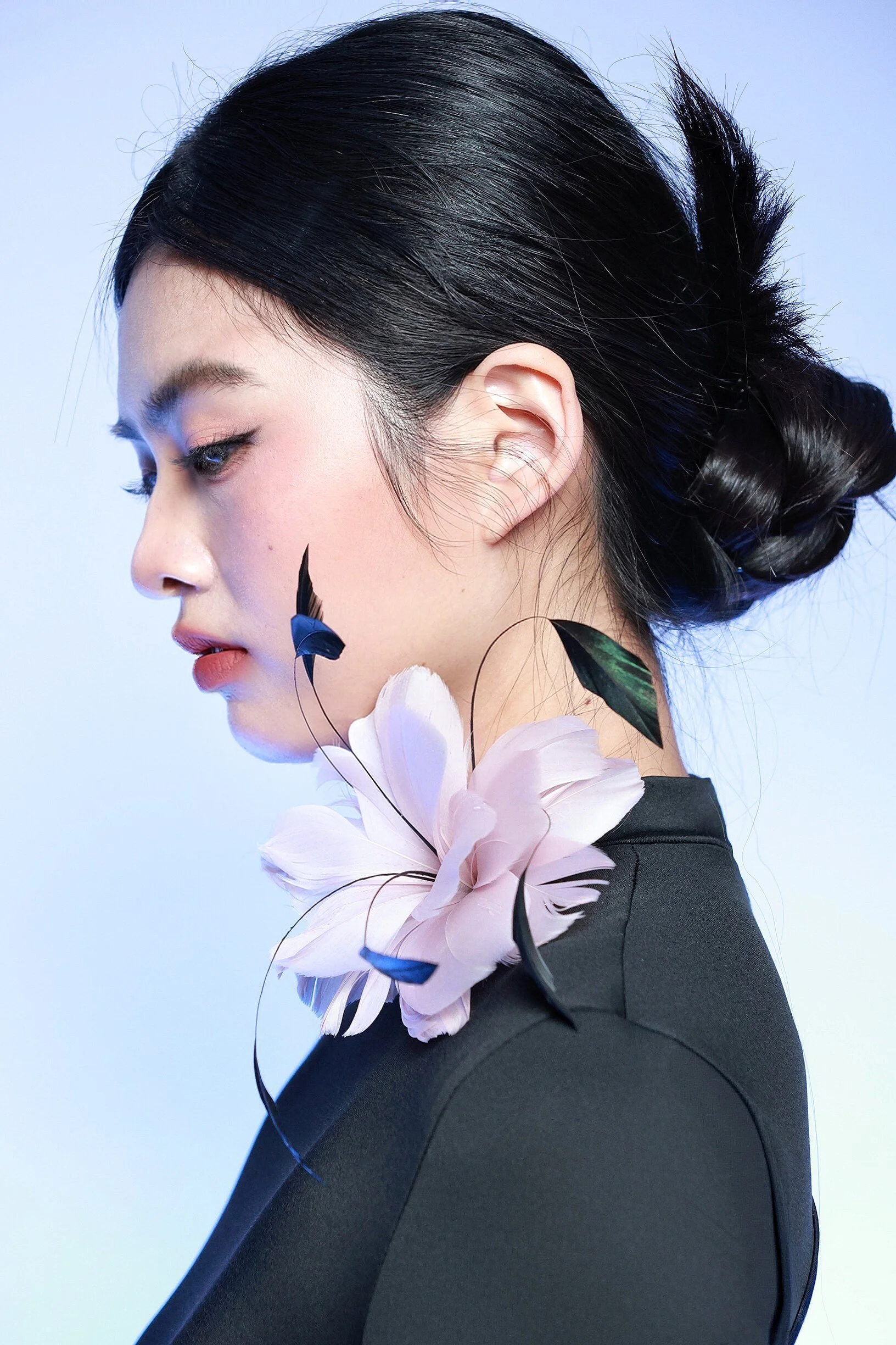 Close-up portrait of a woman in creative lighting and styling
