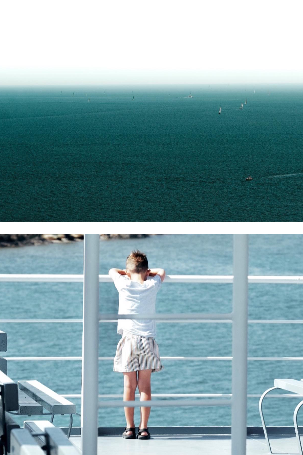 A young boy stands on the deck of a boat, looking out over the ocean with his arms resting on the railing.