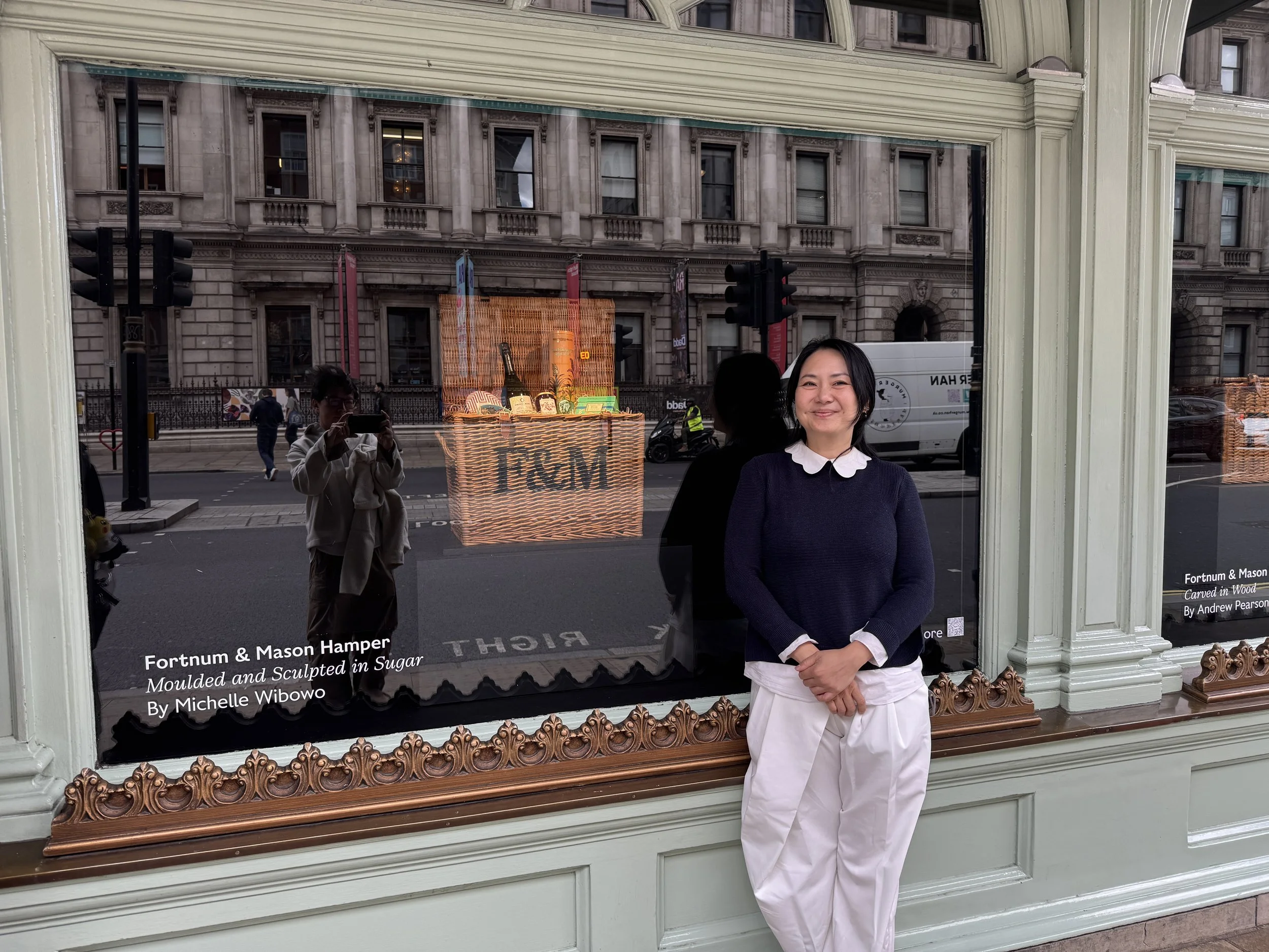 Grammatically Correct Option (British English)  Sugar artist Michelle Wibowo and her creation: the Fortnum & Mason hamper, moulded and sculpted from sugar
