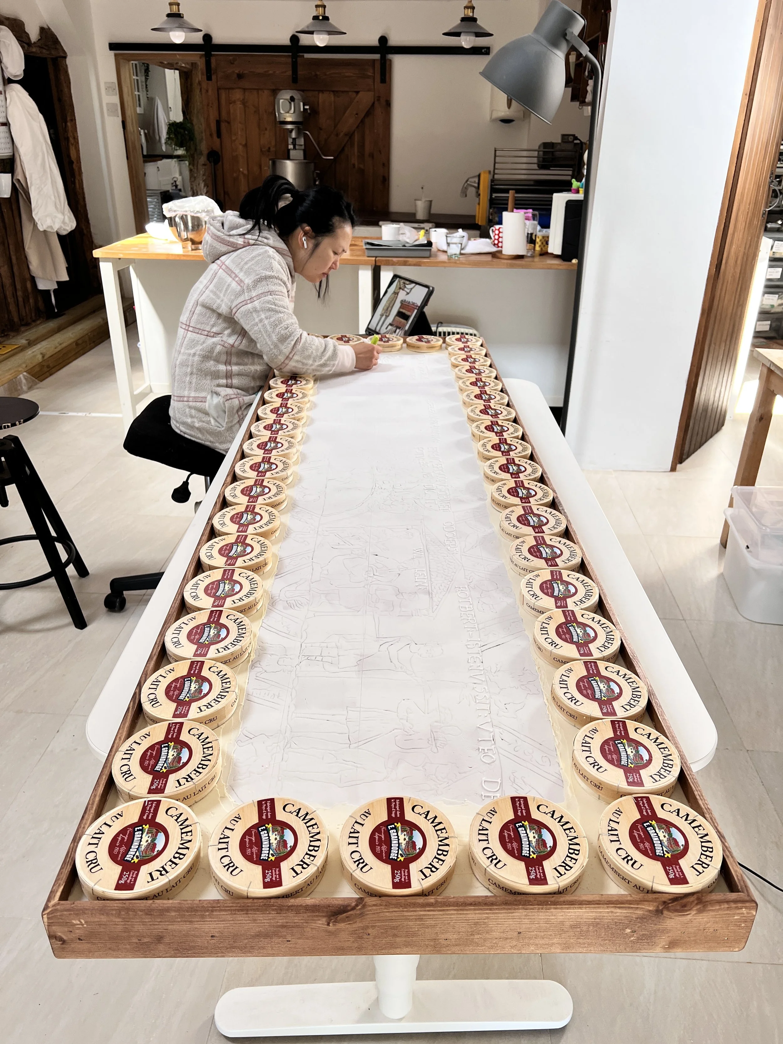 Food artist Michelle Wibowo working on her butter and jam creation of the Bayeux Tapestry in her studio