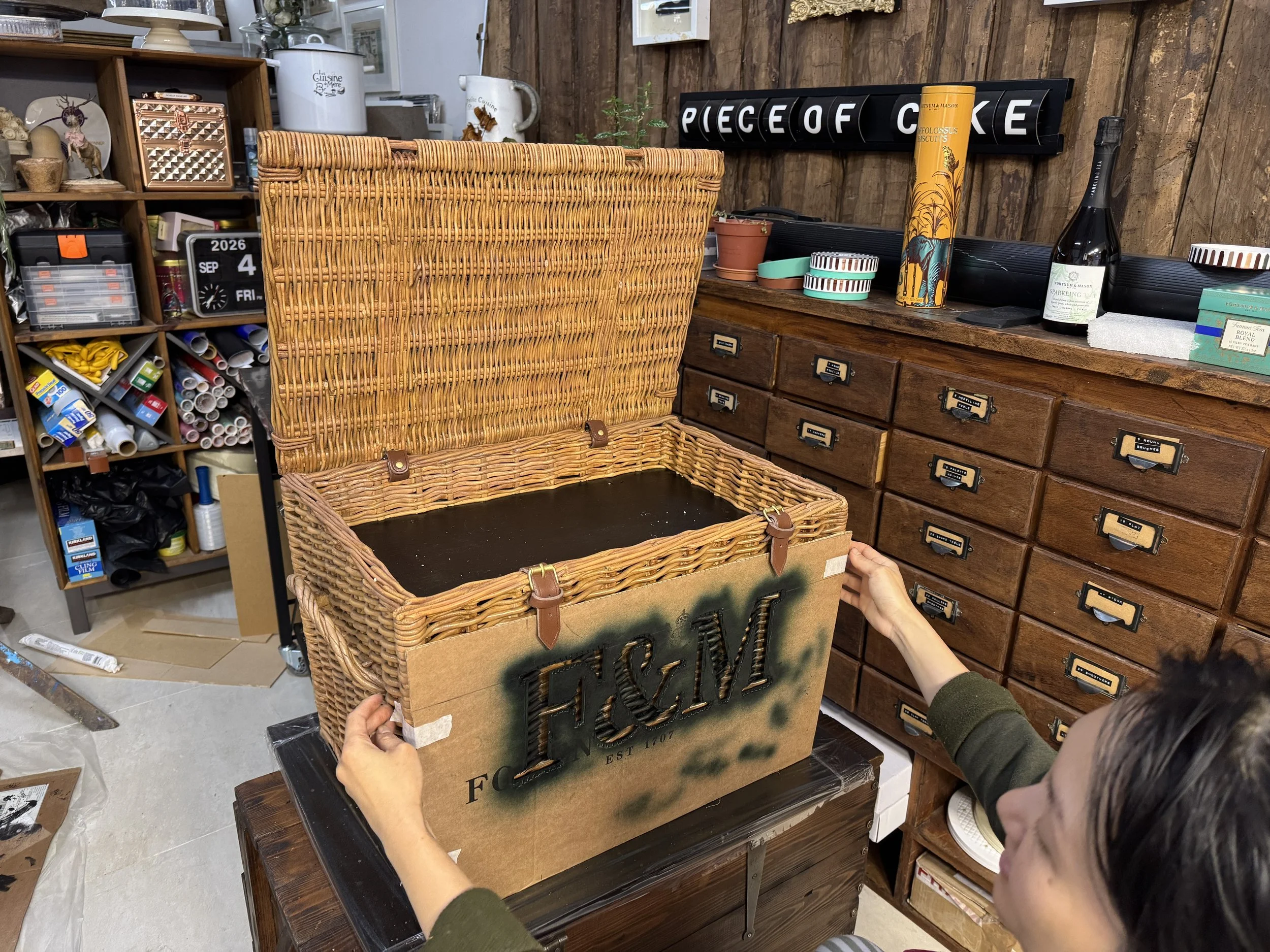 Michelle Wibowo revealing logo of F&M on the hamper
