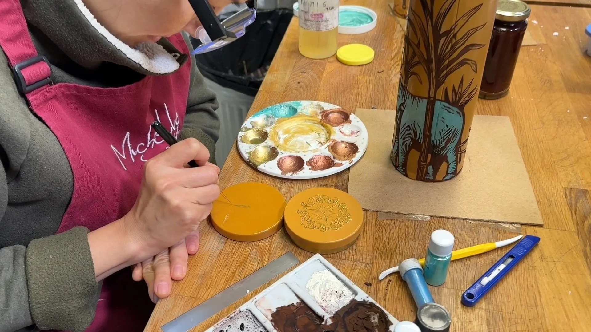 Michelle Wibowo painting the lid of the biscuit tin made out of sugar