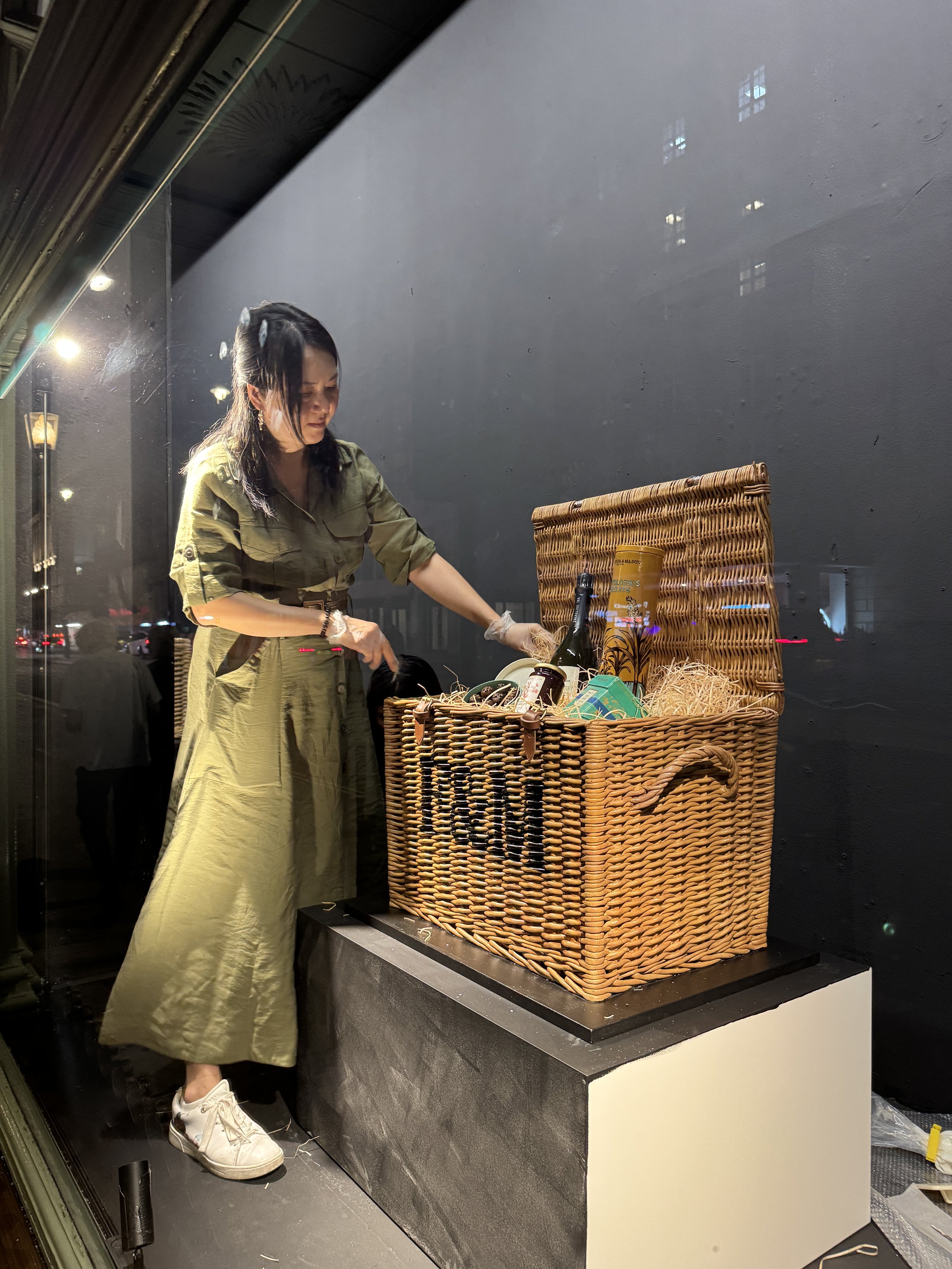 Michelle Wibowo setting up sugar hamper inside Fortnum & Mason Department Store window