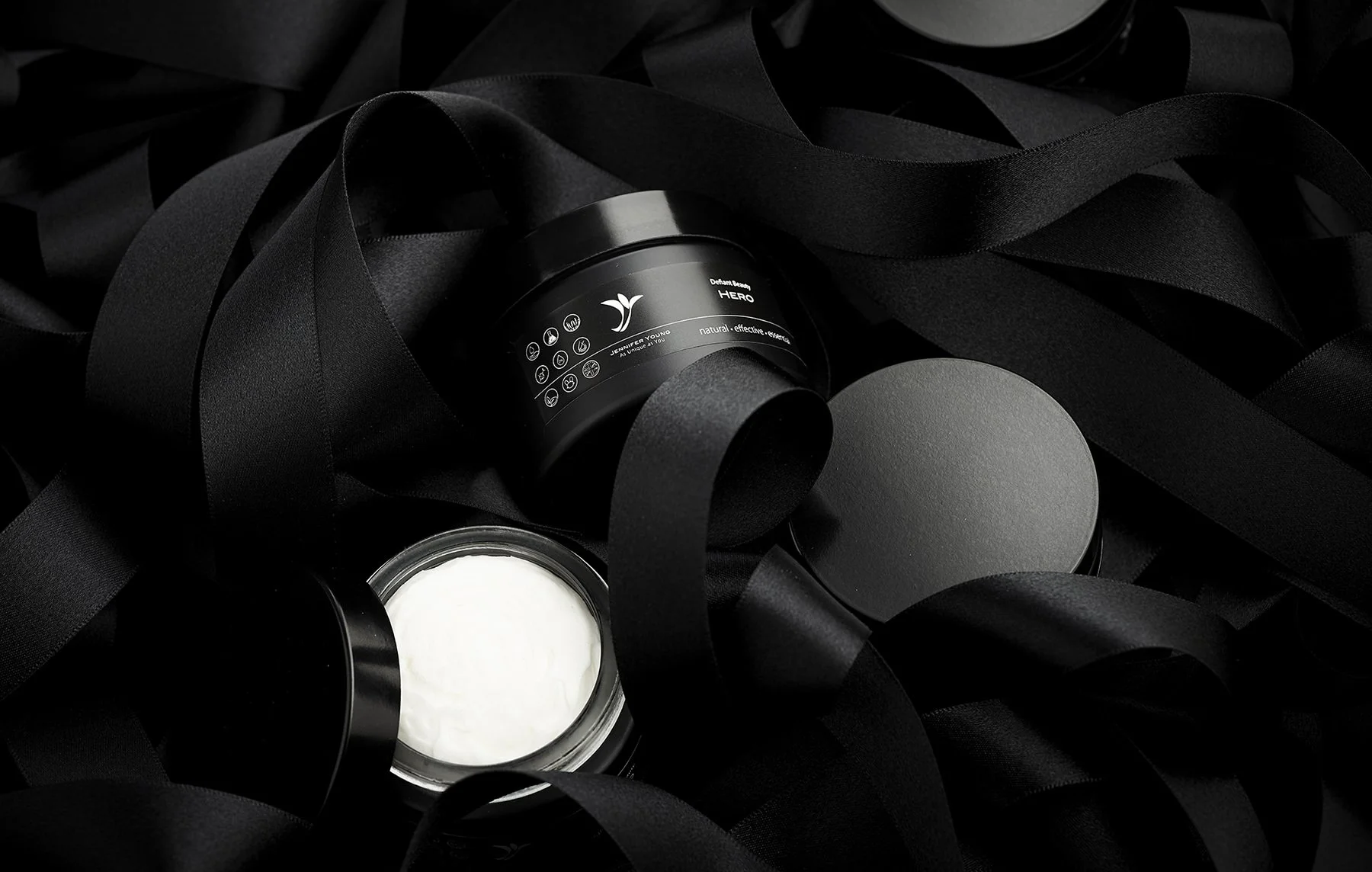 jennifer young skincare and body range product shoot in black ribbon by alex bibby photography