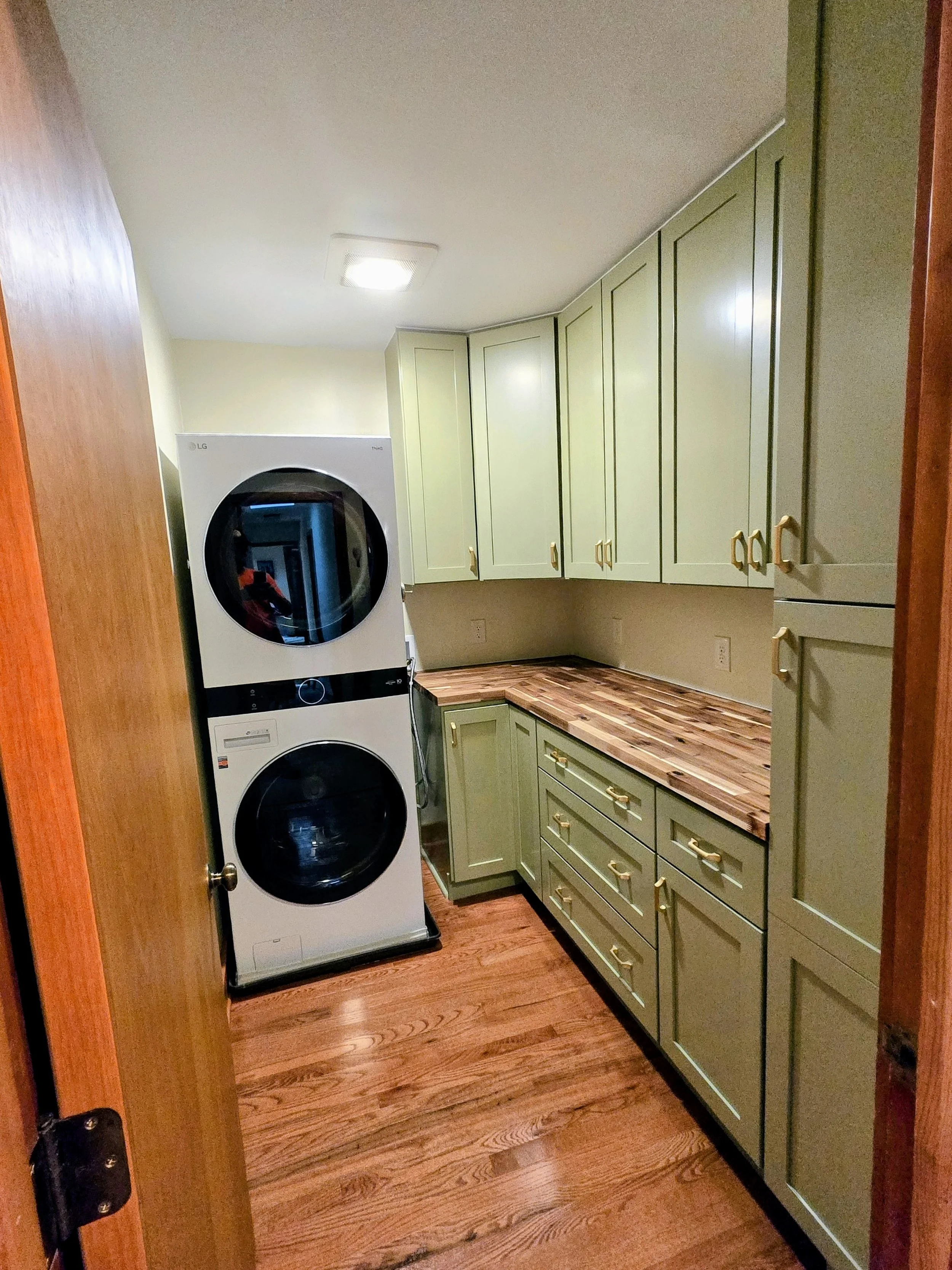 Custom butcher block counter top, custom cabinets, and hardwood flooring to match