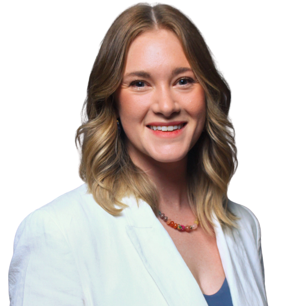 A young woman with blonde hair, blue eyes, and fair skin, smiling at the camera, wearing a white and blue top and a multicolored necklace, against a plain white background.