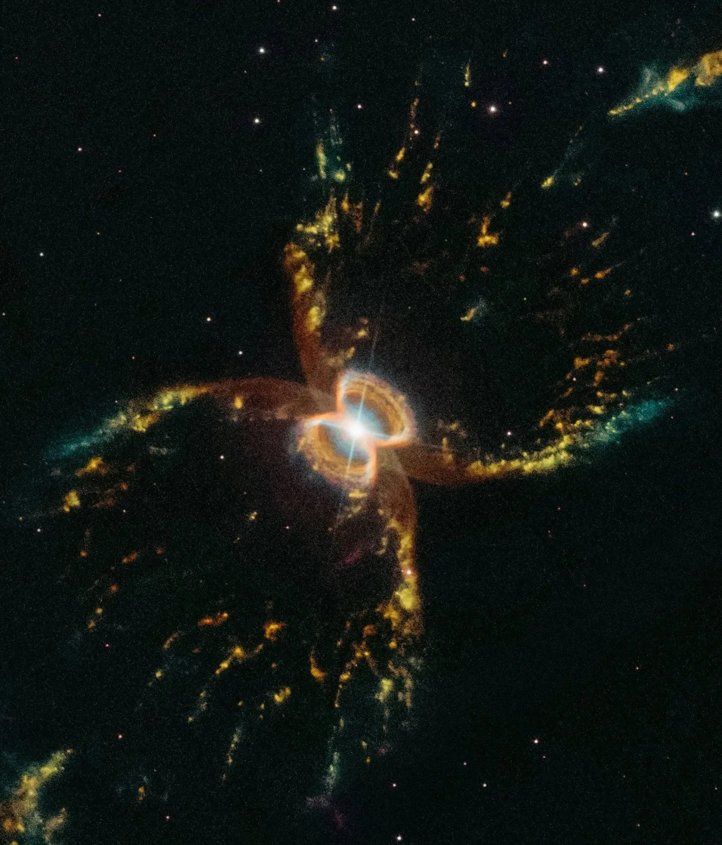 Bright explosion of colors in space with yellow, orange, blue, and white glowing areas surrounded by stars and dark space.
