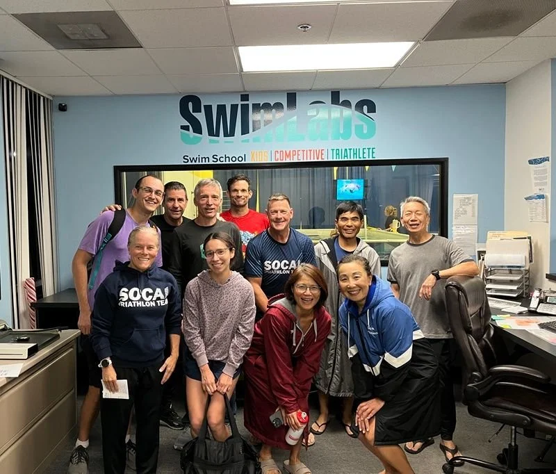 SoCal Triathlon team enjoying their first SwimLabs team night in Irvine, Orange County. Coaches delivering personalized swim technique feedback for faster swimming. Real-time video analysis shows instant stroke improvements during this fun group sess