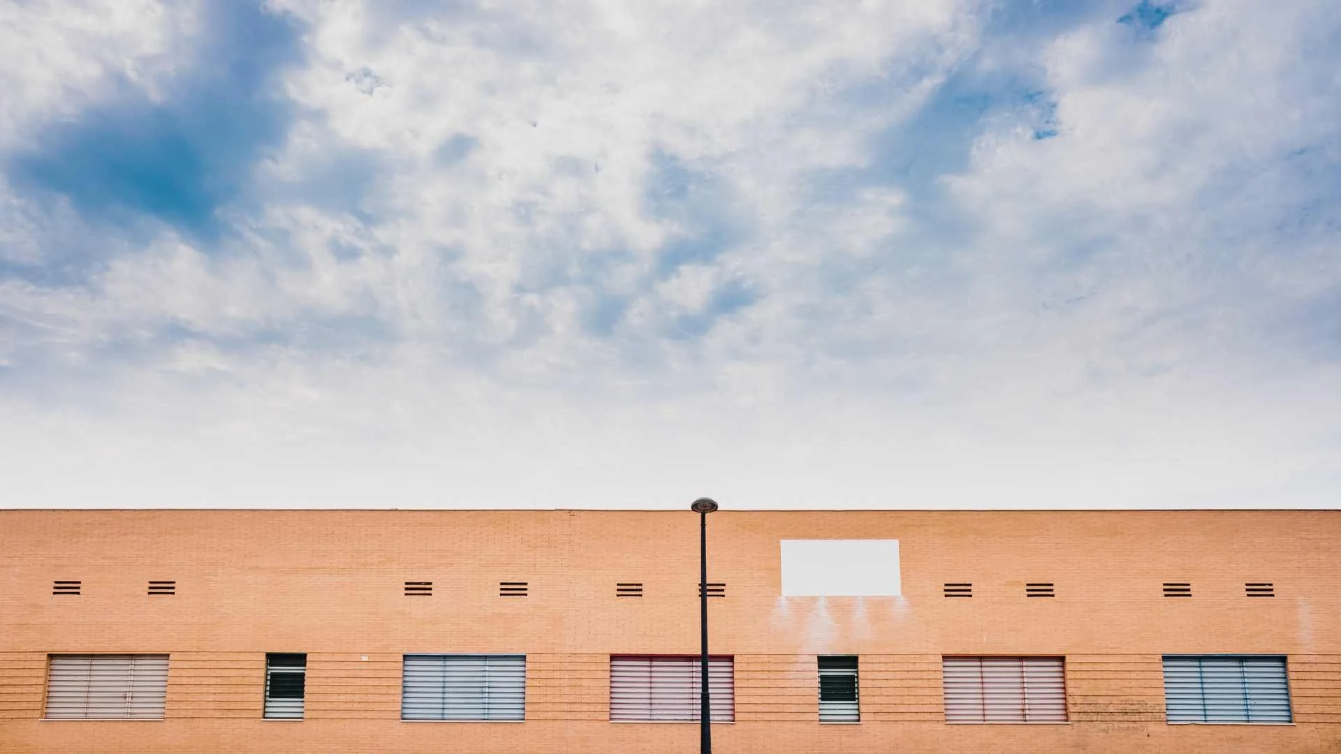 a red brick building with a flat roof surface