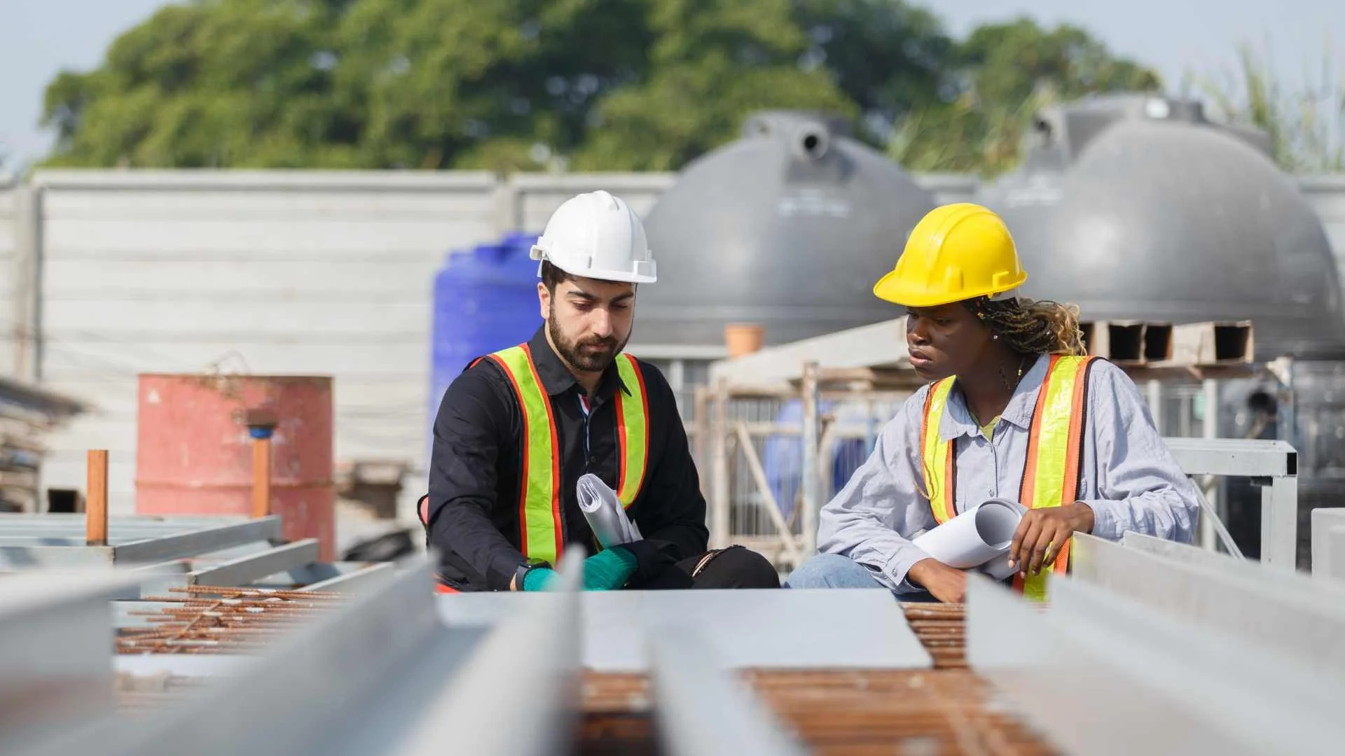 a roofer with a white hard hat talking to a contractor about a roof repair job