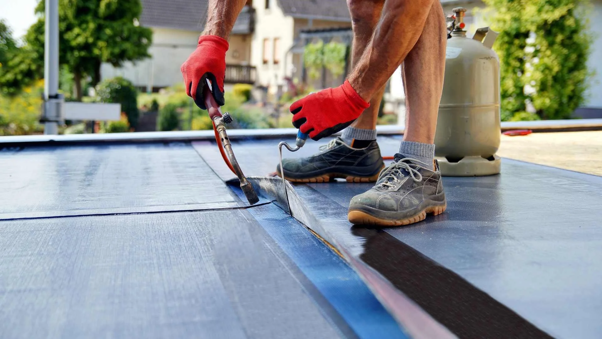 a roofer using tools on a gulf coast commercial building