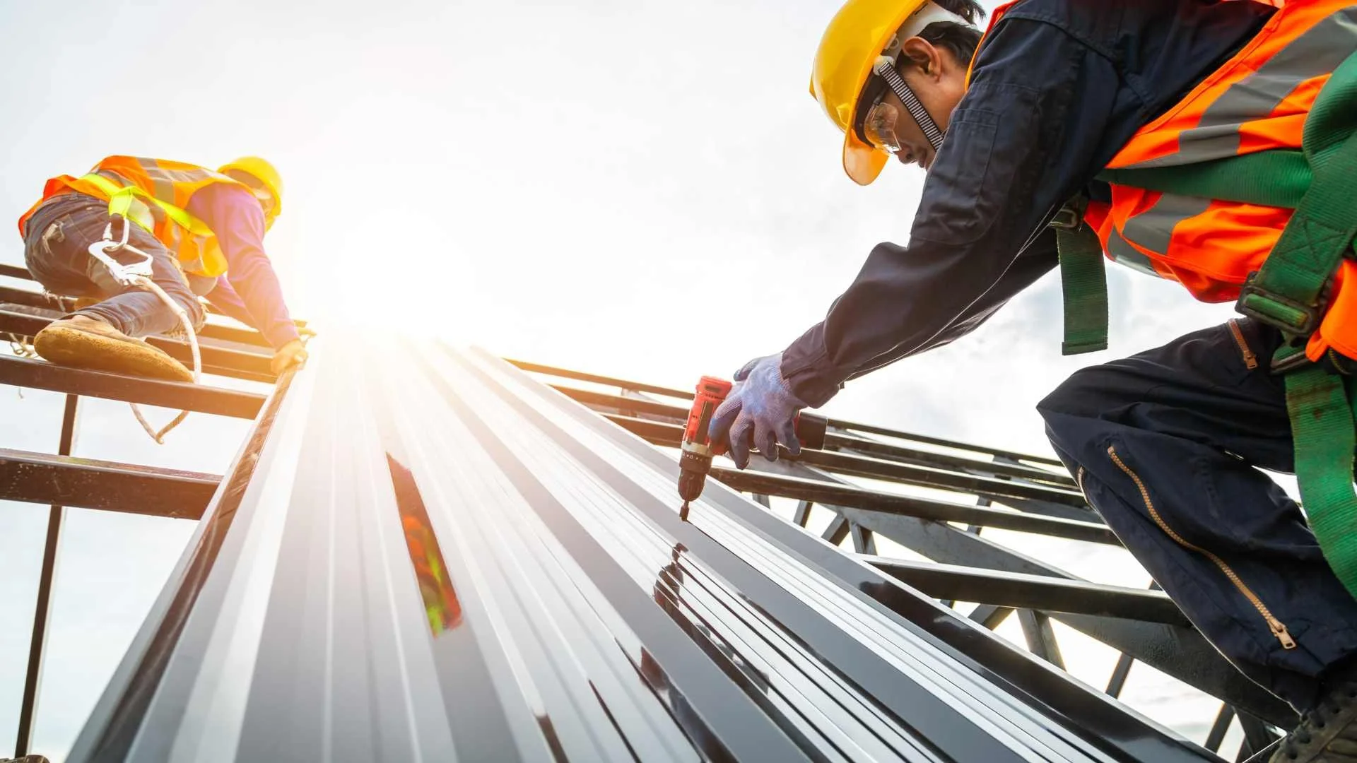 a roofer installing a metal commercial roof