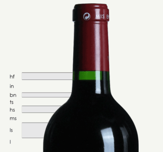 Close-up of a wine bottle with a red cap and a green neck label, against a light background.