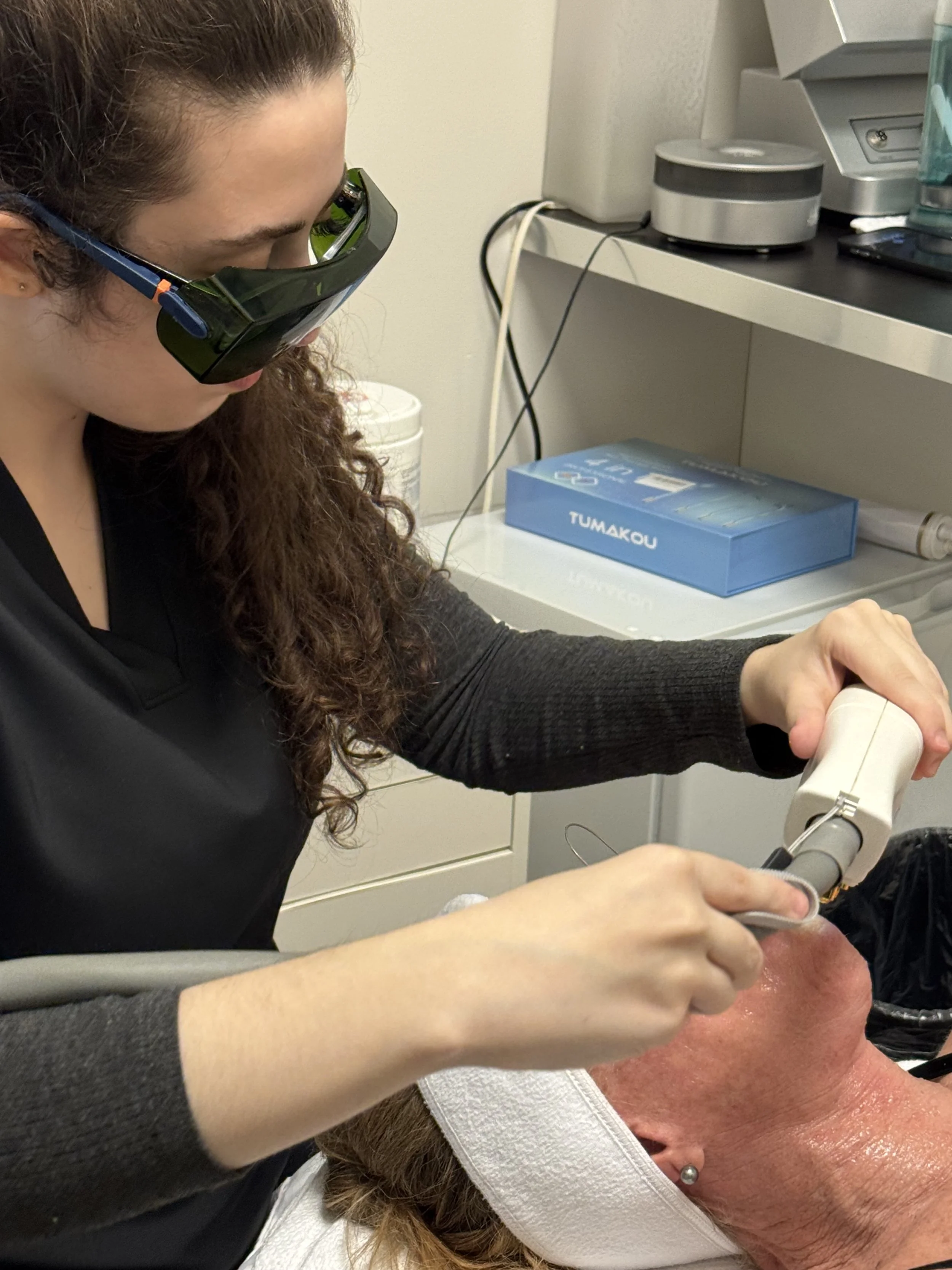 Alma Esthetics esthetician Addison performing a laser skin tightening BBL treatment