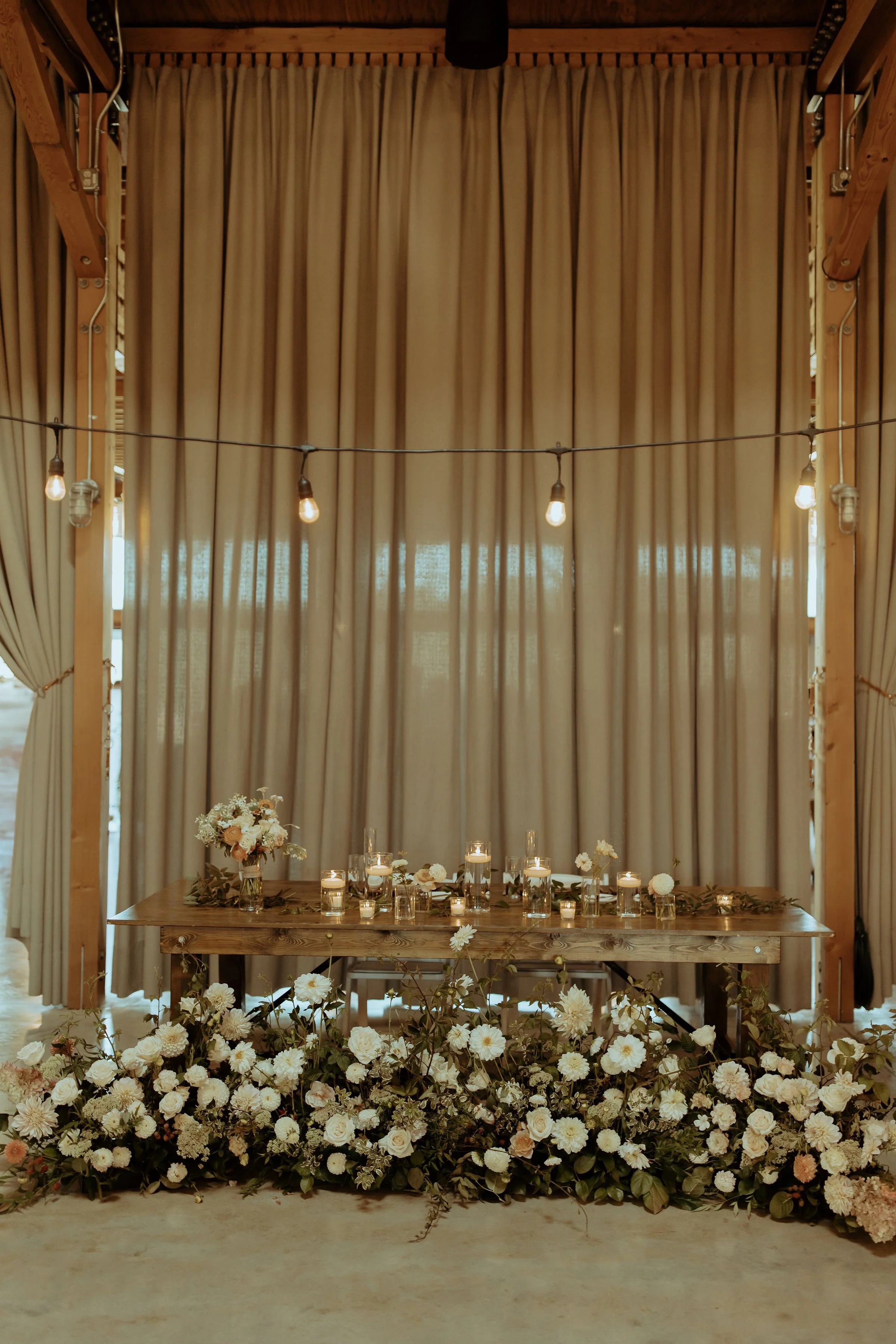 A romantic sweetheart table framed by floor-length blooms and candlelight.