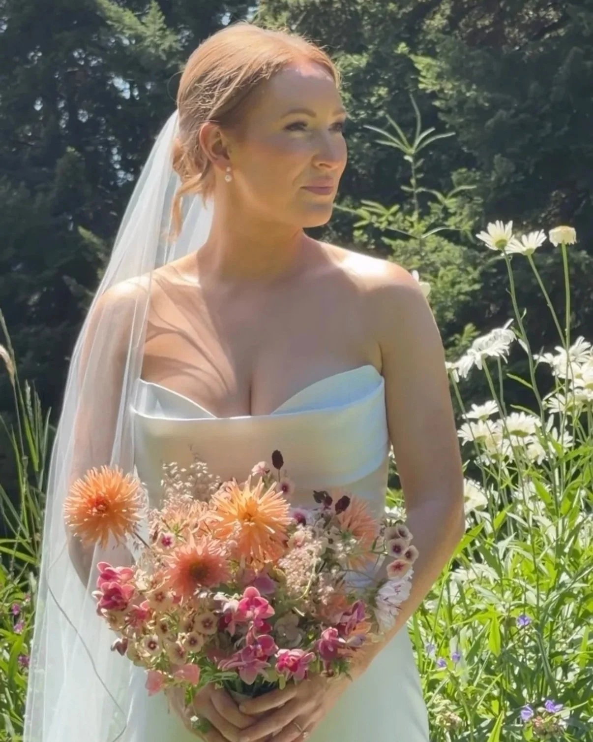 Summer bride holding a garden - inspired wedding bouquet by Portland floral designer, Roots of Joy at Gorge Crest VIneyards.