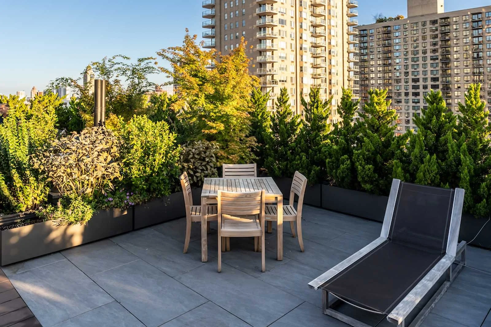 Manhattan rooftop patio with dining table and lounge seatingv