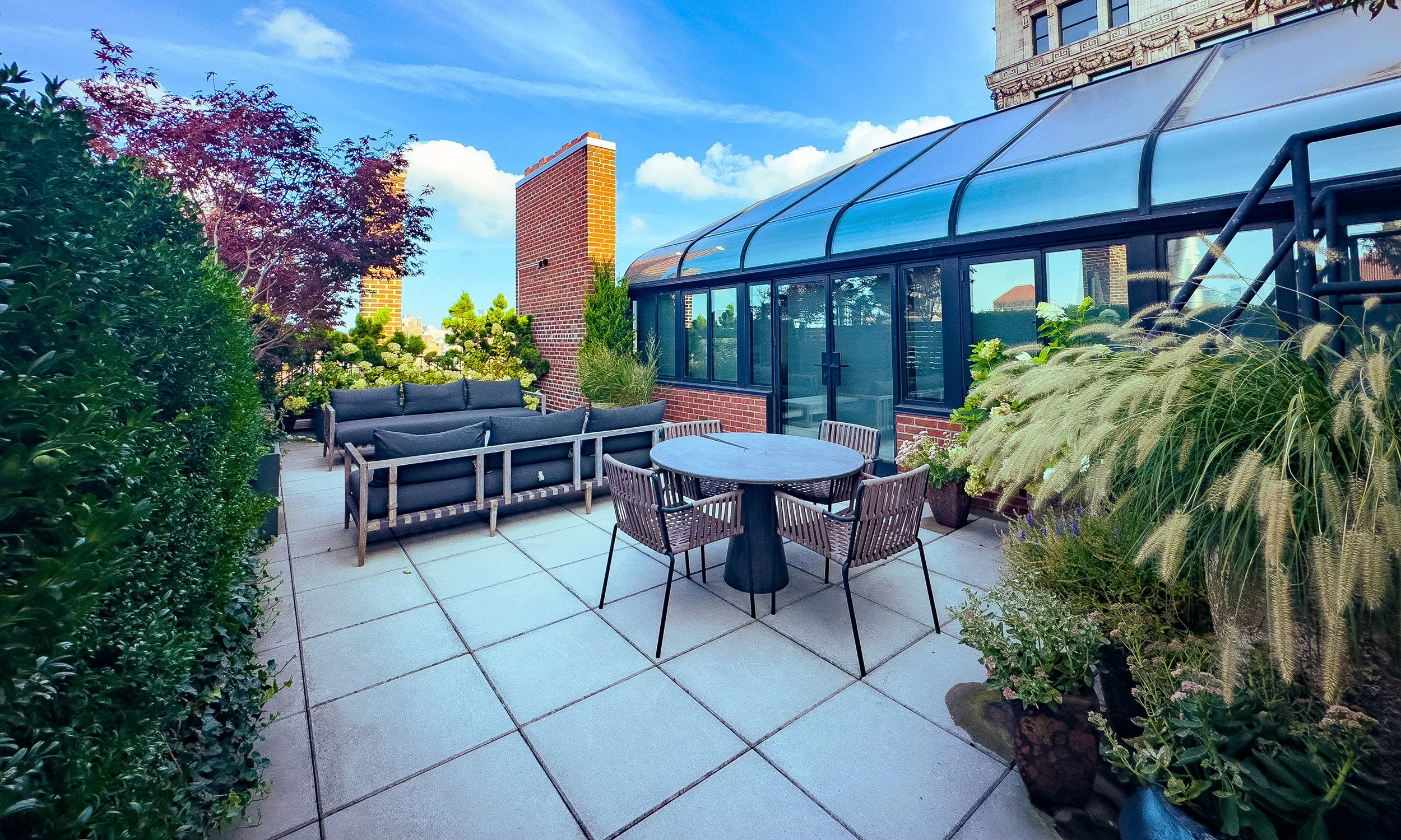 garden-rooftop-patio-with-table-and-greenery.jpg