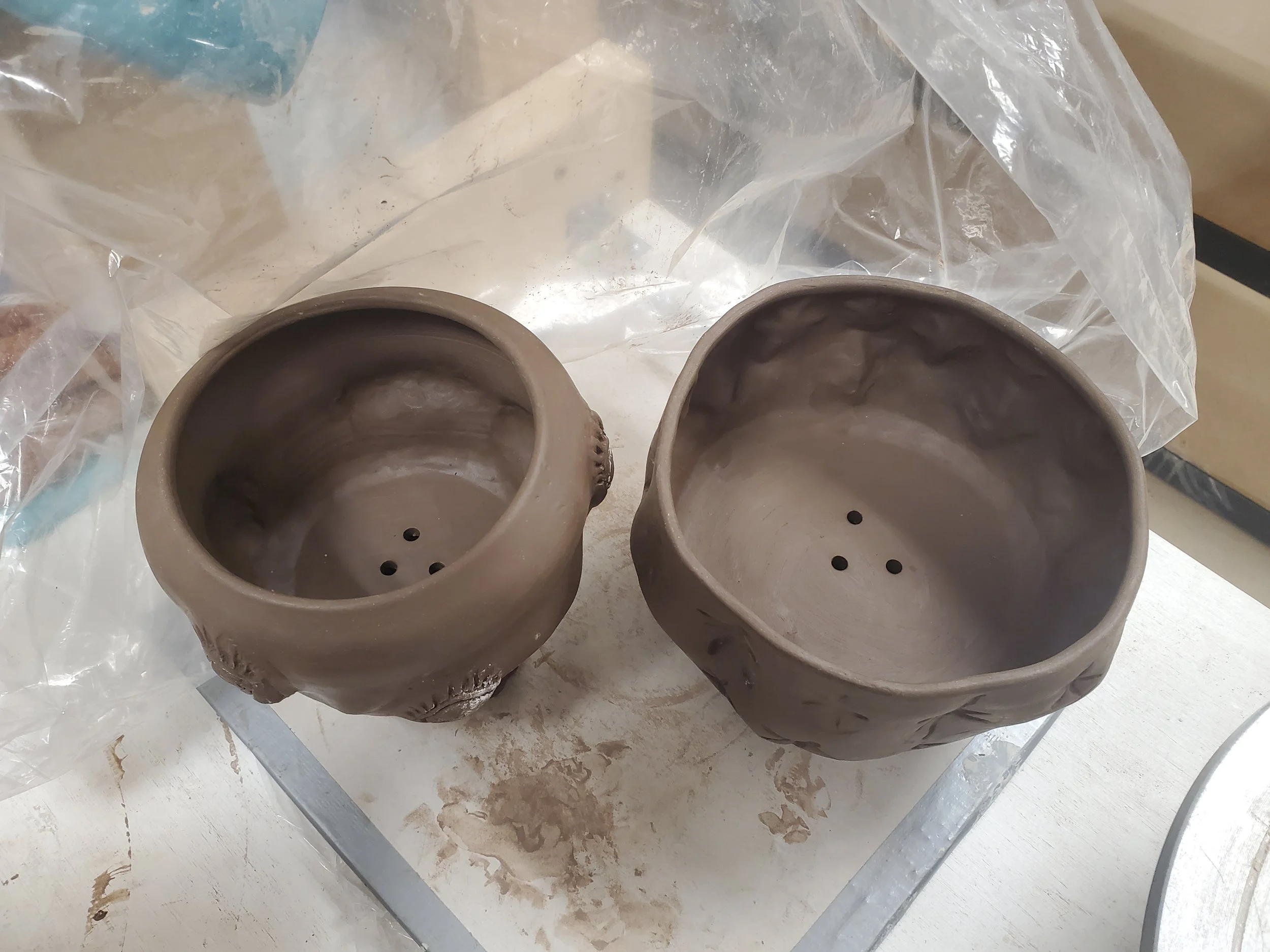 two planters with drainage holes punched