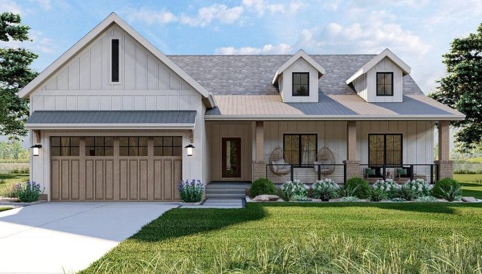 Modern farmhouse with light-colored siding, stone accents, and a covered porch. Features include a gabled roof, two dormers, and a wooden garage door. Landscaping with green plants and bushes enhances the front yard.