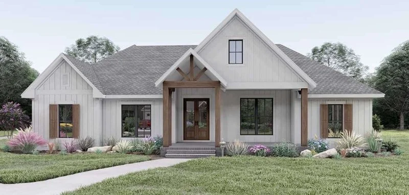 Modern farmhouse with gray siding, gabled roof, wooden accents, and a landscaped front yard. Paved pathway leads to the entrance.