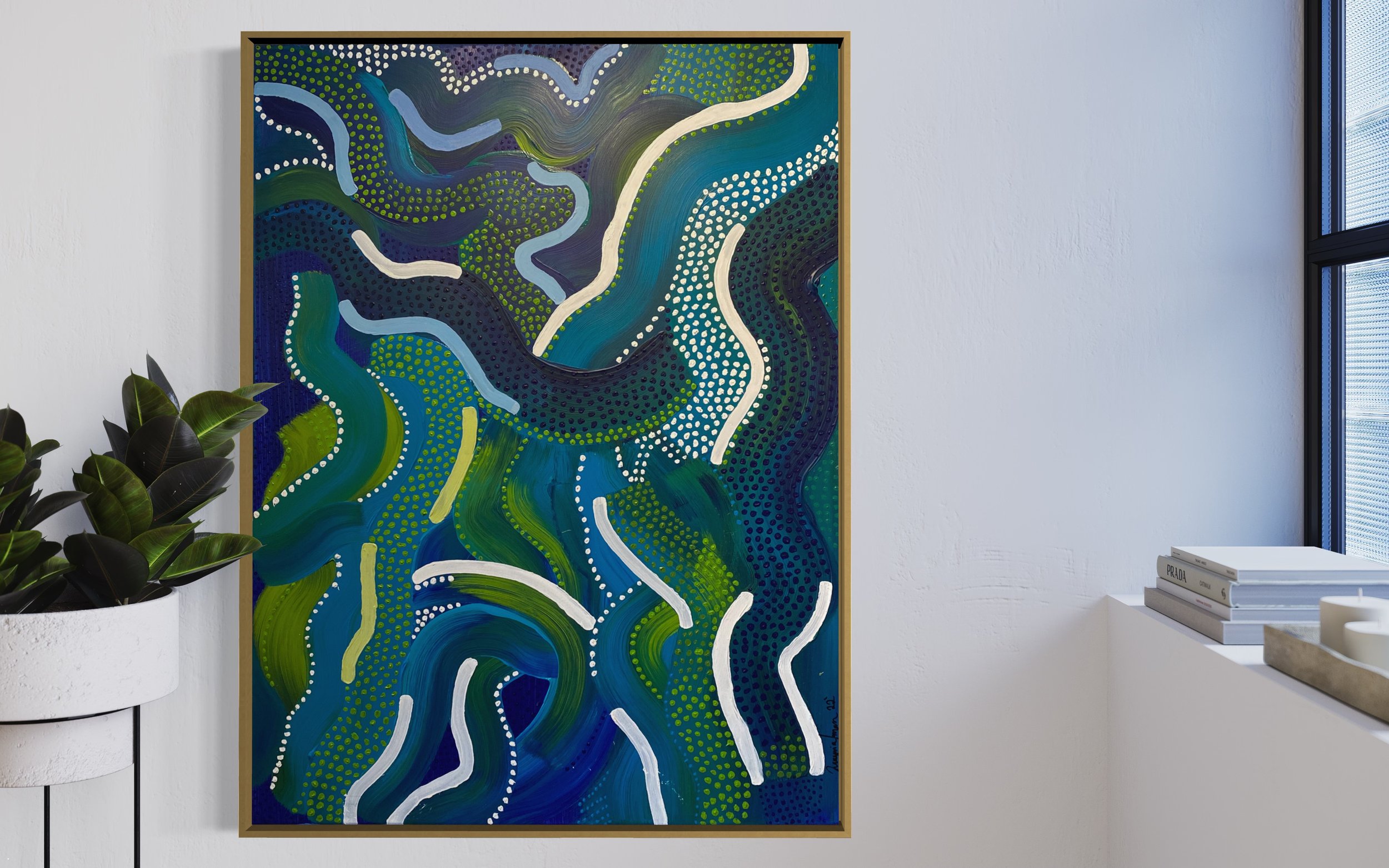 Abstract painting with wavy, multicolored lines featuring blue, green, and white shades. Framed and hanging on a white wall next to a potted plant and a stack of books.