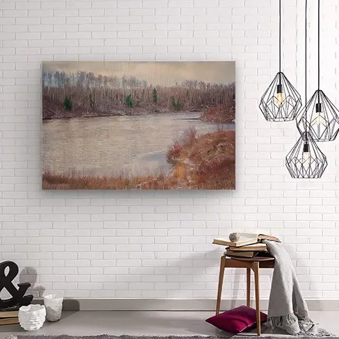 Minimalist area with white brick wall, grey floor, hanging pendant lights, accessories and Meadow Creek printed on wood hanging on the wall.