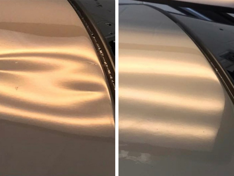 Paintless dent removal on hood of car.