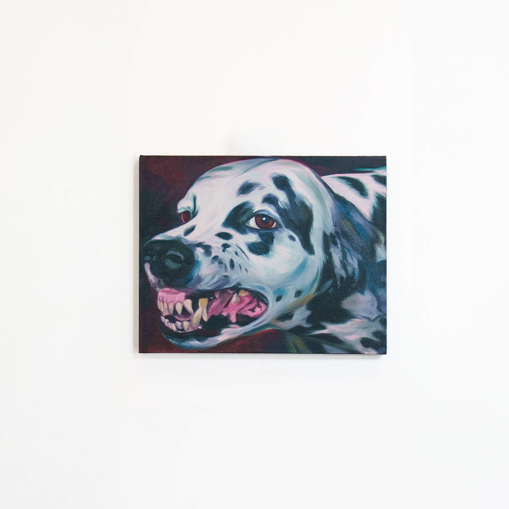 Painting of a fierce-looking Dalmatian dog with sharp teeth, black spots, and expressive eyes on a plain white wall.