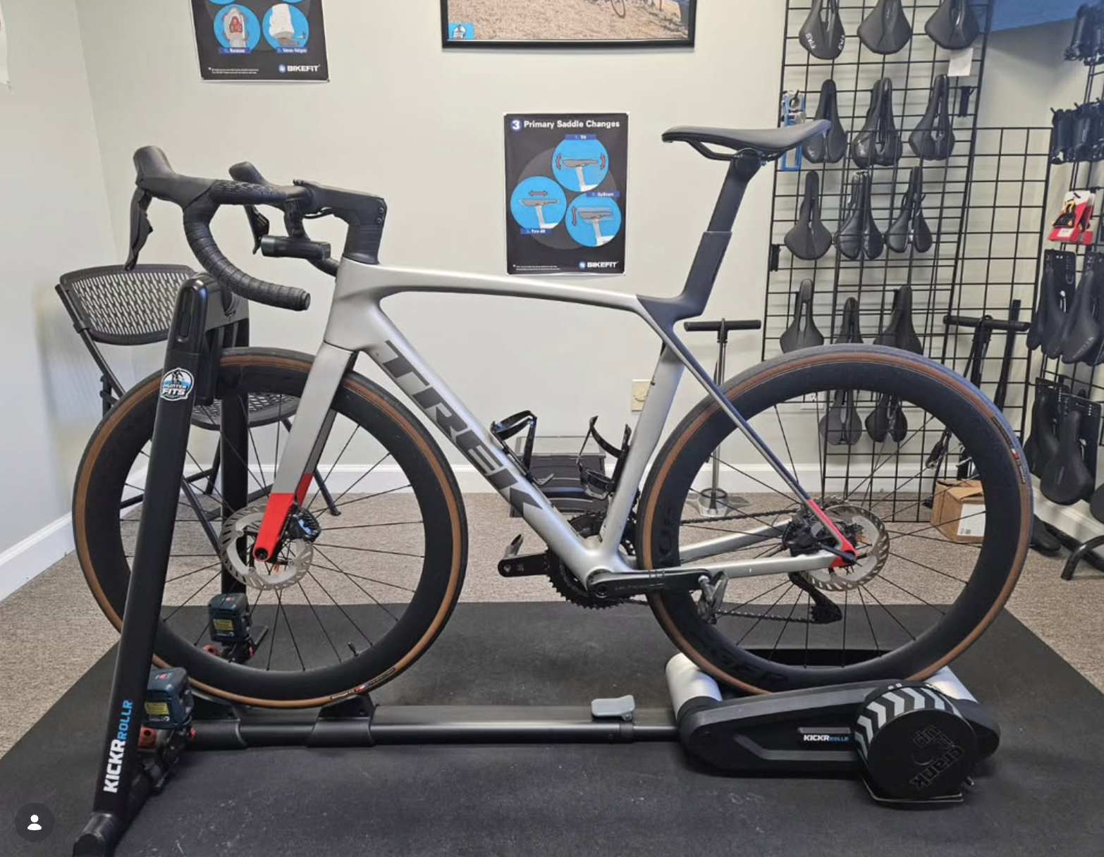 Outline drawing of a bicycle in blue on a black background.