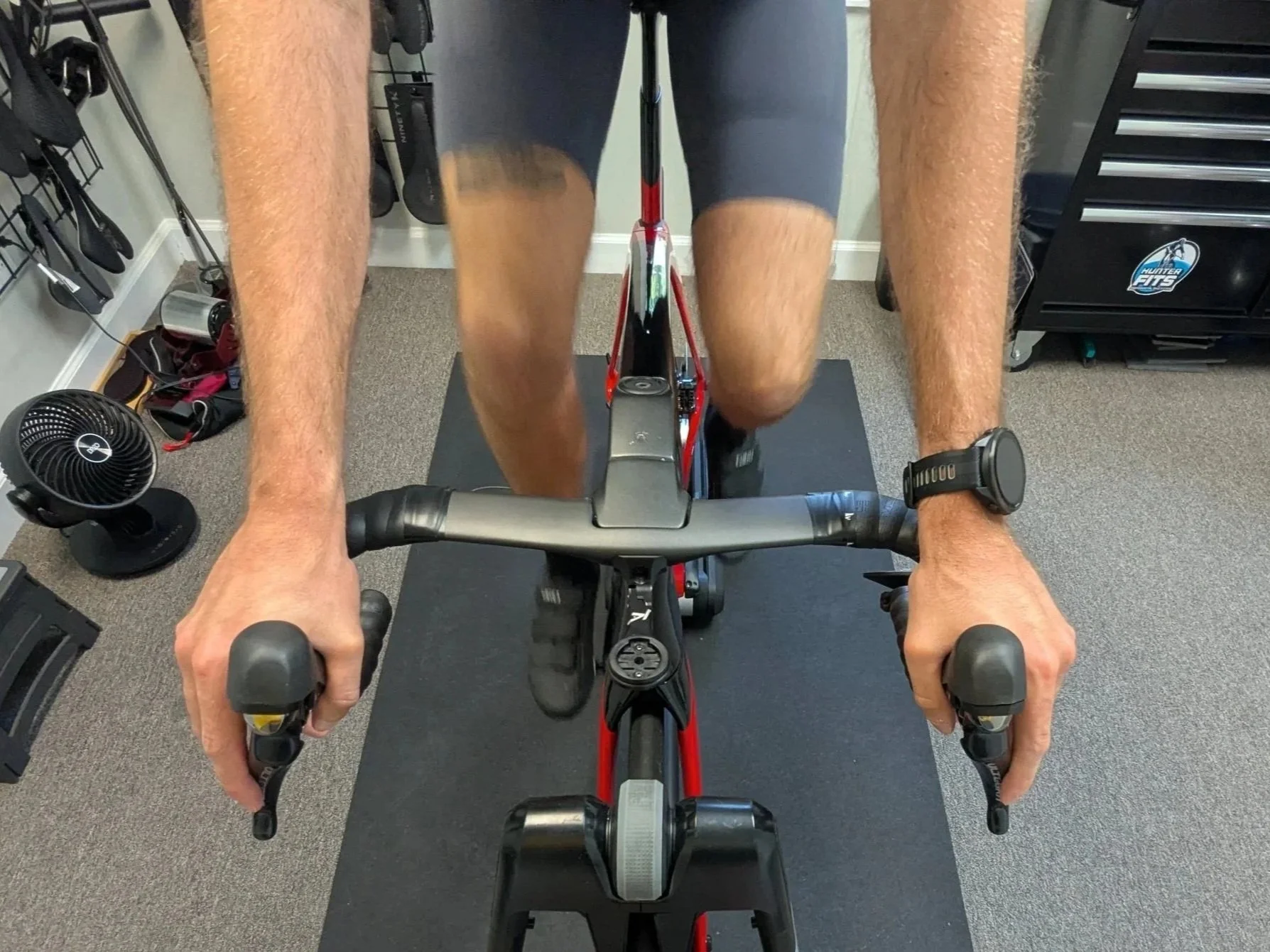 Cyclist on a bike with hands on the handlebar hoods