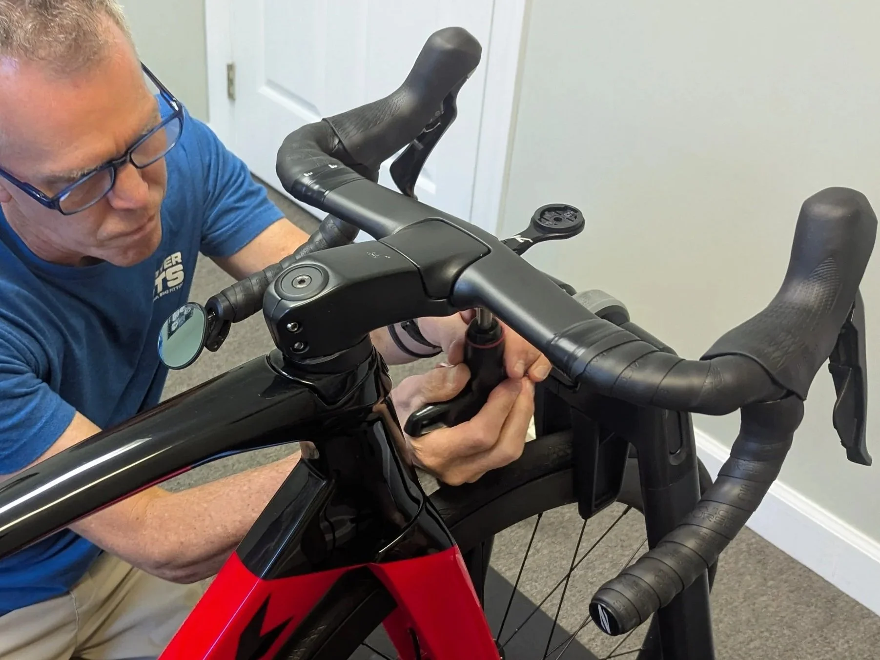 Todd Hunter working on adjusting the handlebar position of a bicycle