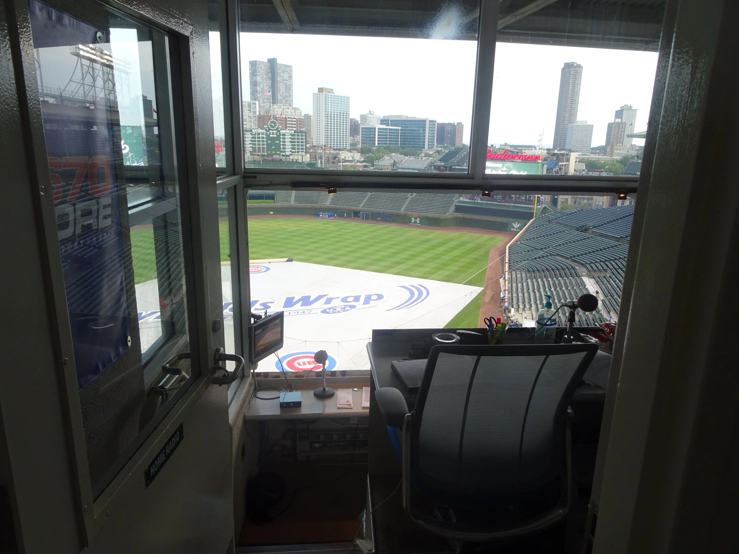   The Home Radio Booth  – The view from the back of the Cubs radio booth at Wrigley Field.&nbsp; All-time greats such as Jack Brickhouse, Vince Lloyd, Harry Caray, Ron Santo and Lou Boudreau have graced this booth over the centuries.&nbsp; The radio 