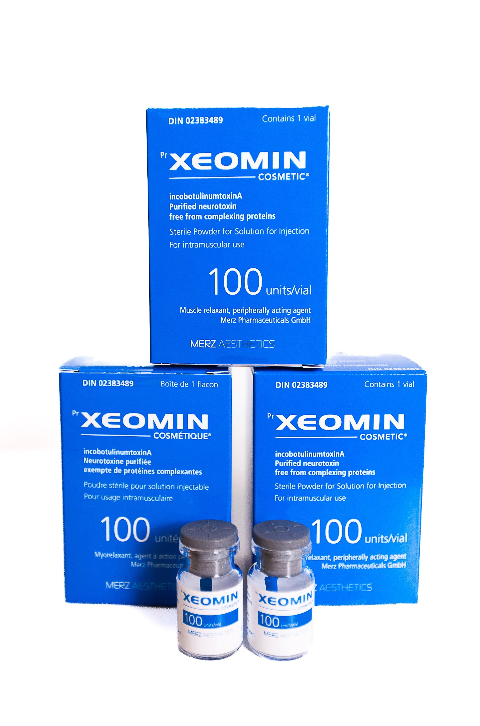 Boxes and vials of Xeomin, a purified neurotoxin for muscle relaxation, displayed upright against a white background.