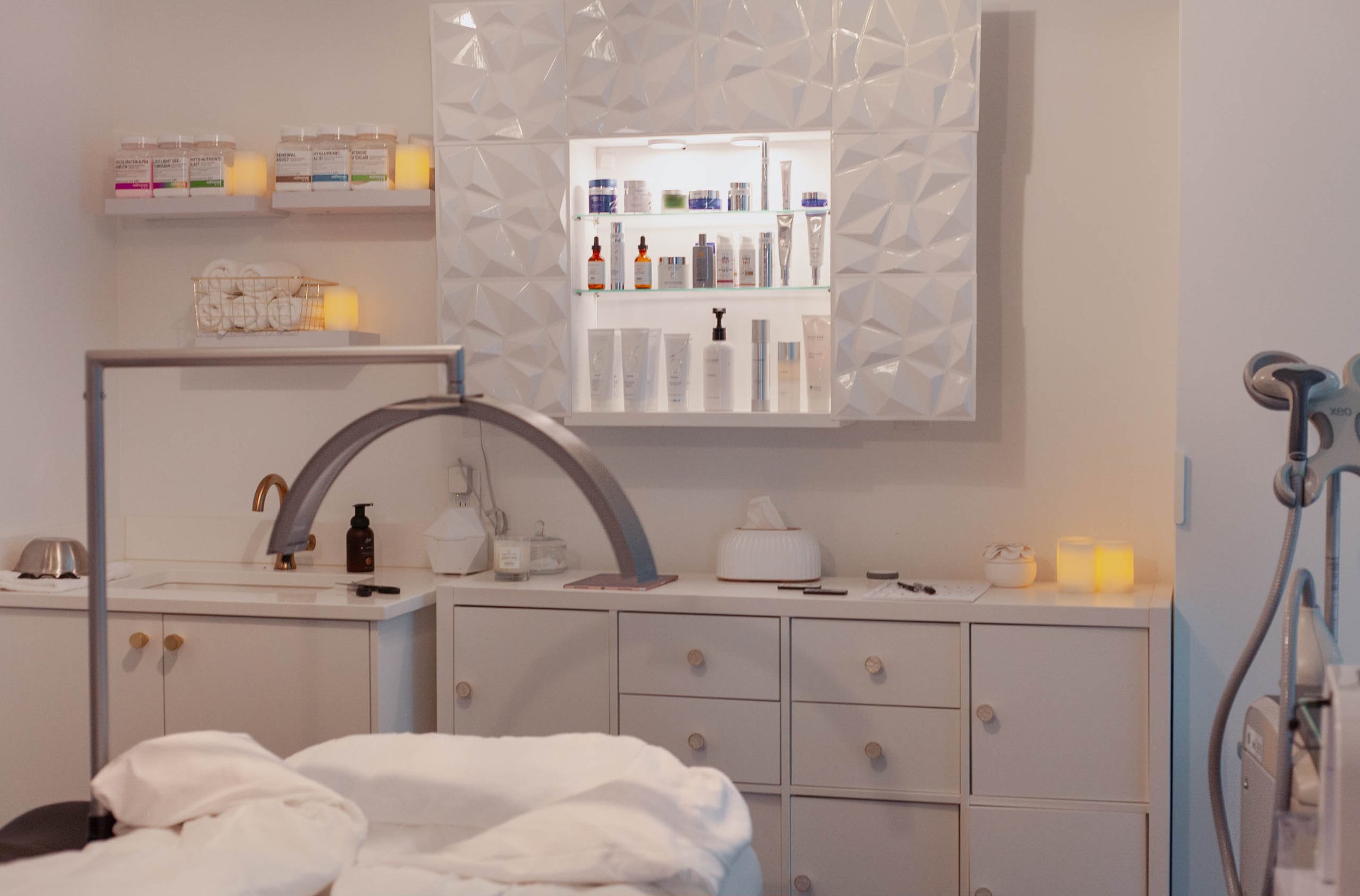 A spa room with shelves with skincare products.
