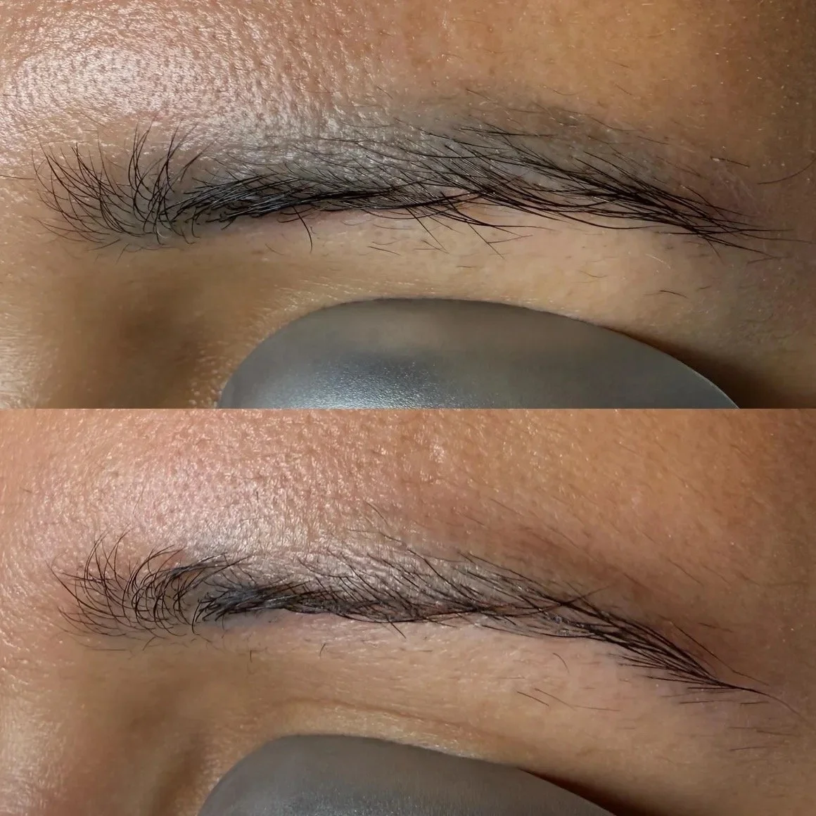 Close-up of a person's closed eyelids showing natural eyebrows and eyelashes, with one eye covered by a gray object, likely a makeup or skincare tool.