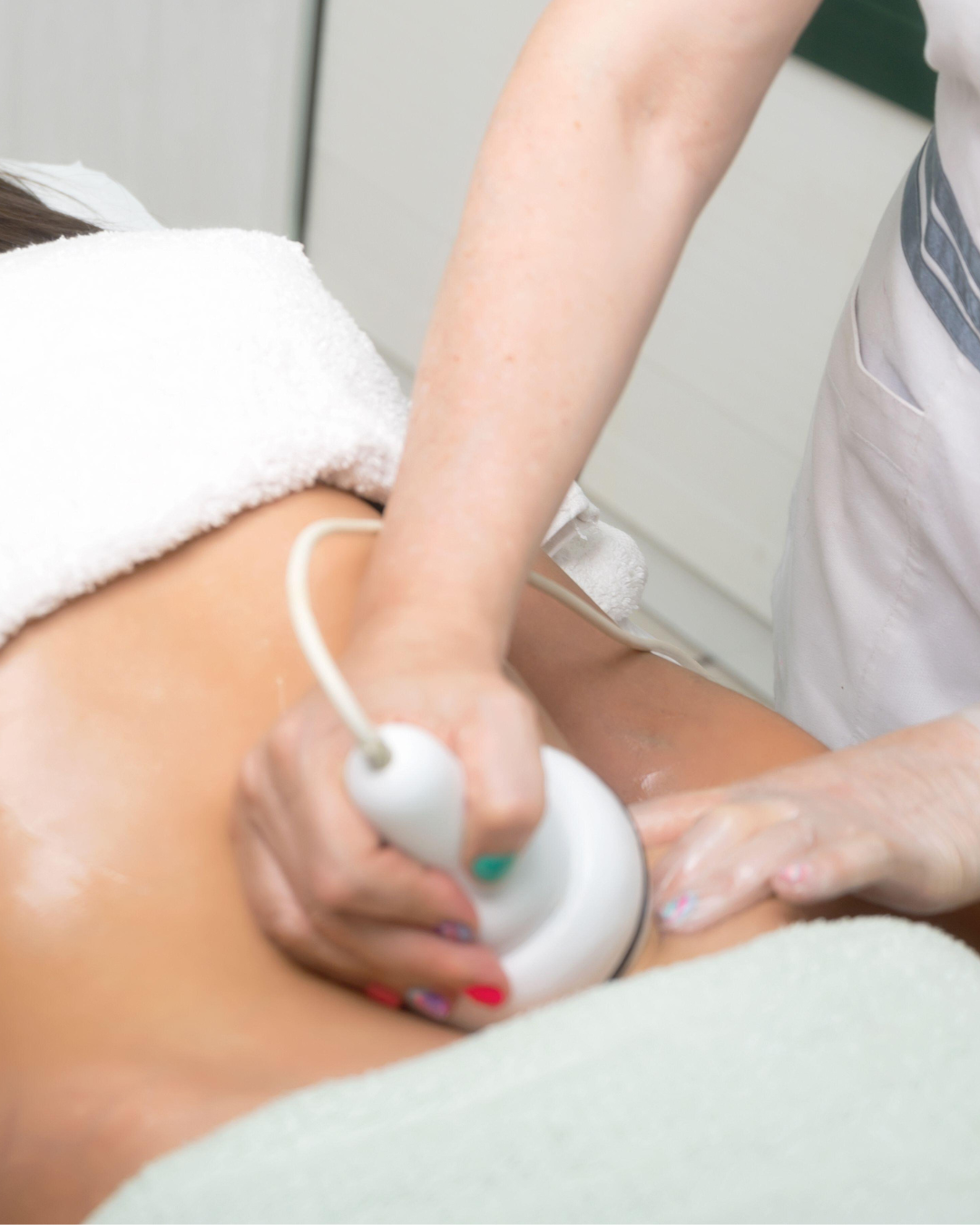 A healthcare professional performing an ultrasound on a patient's abdomen.