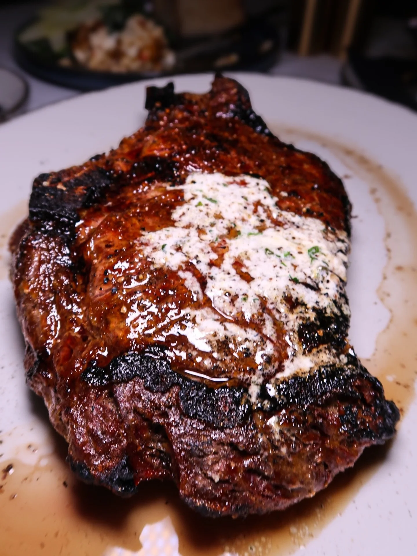 Our Delmonico is a true nod to tradition&mdash;thick-cut, beautifully marbled, and known for its rich, tender bite. Inspired by the legacy of the original Delmonico&rsquo;s, this classic steak is broiled and finished with garlic herb butter to bring 