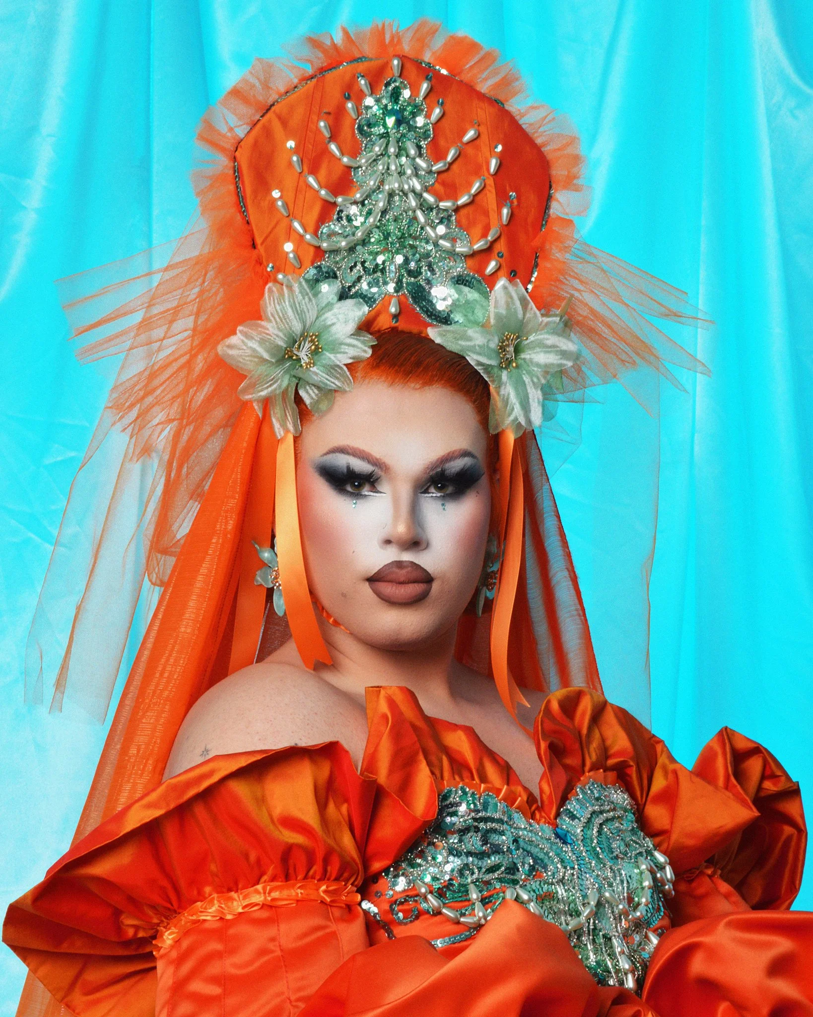 Image of drag artist Atomic Annie against a blue background shot on digital