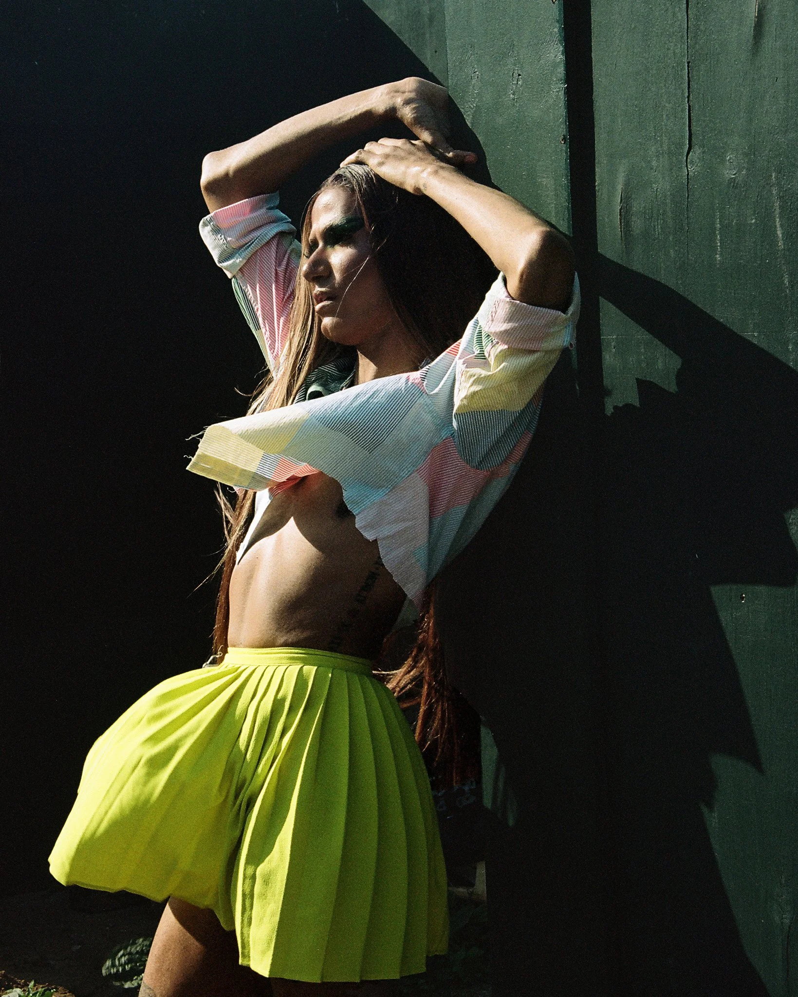 Image of drag artists against a green background on film