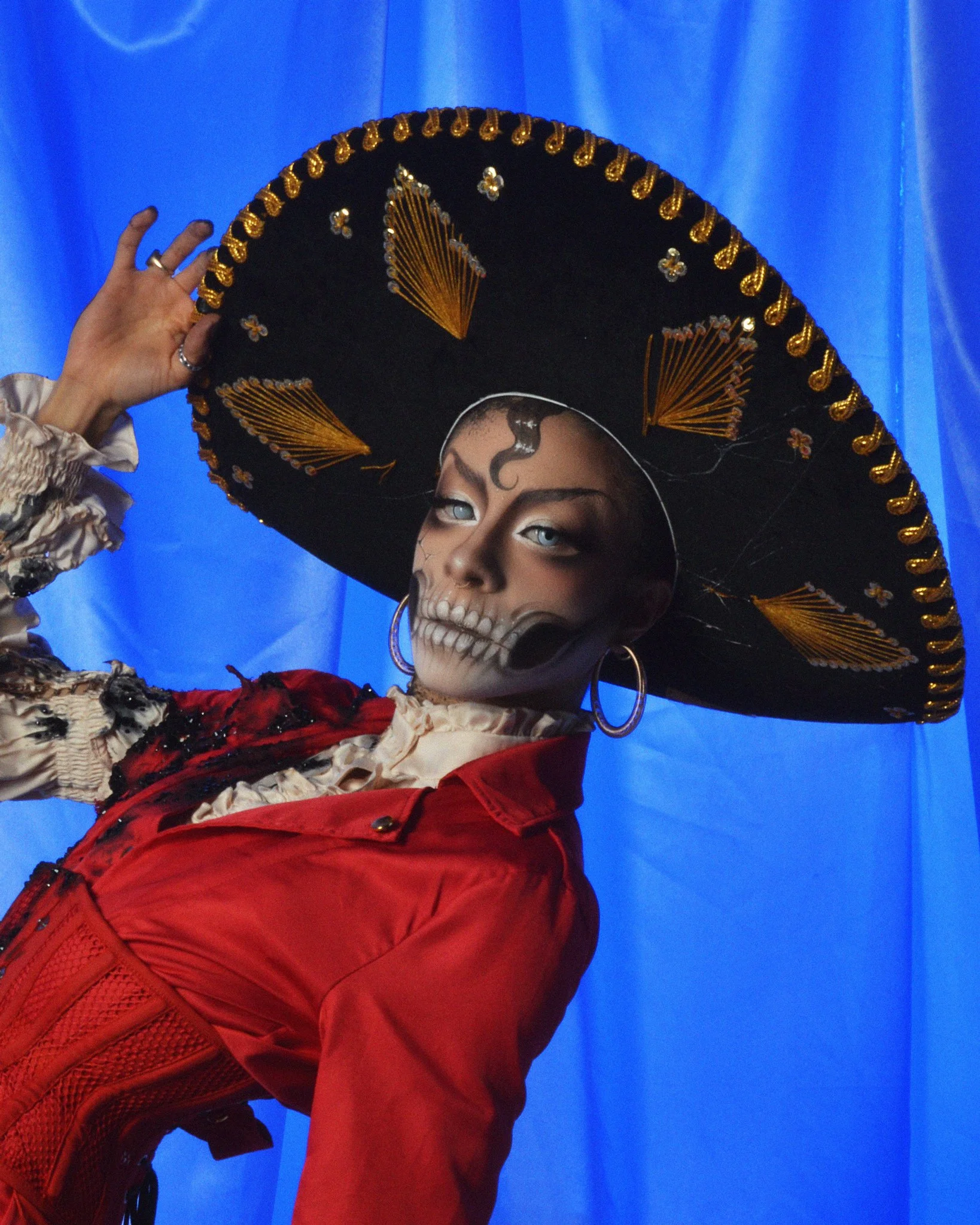 Image of drag artist Xana Horia against a blue background shot on digital
