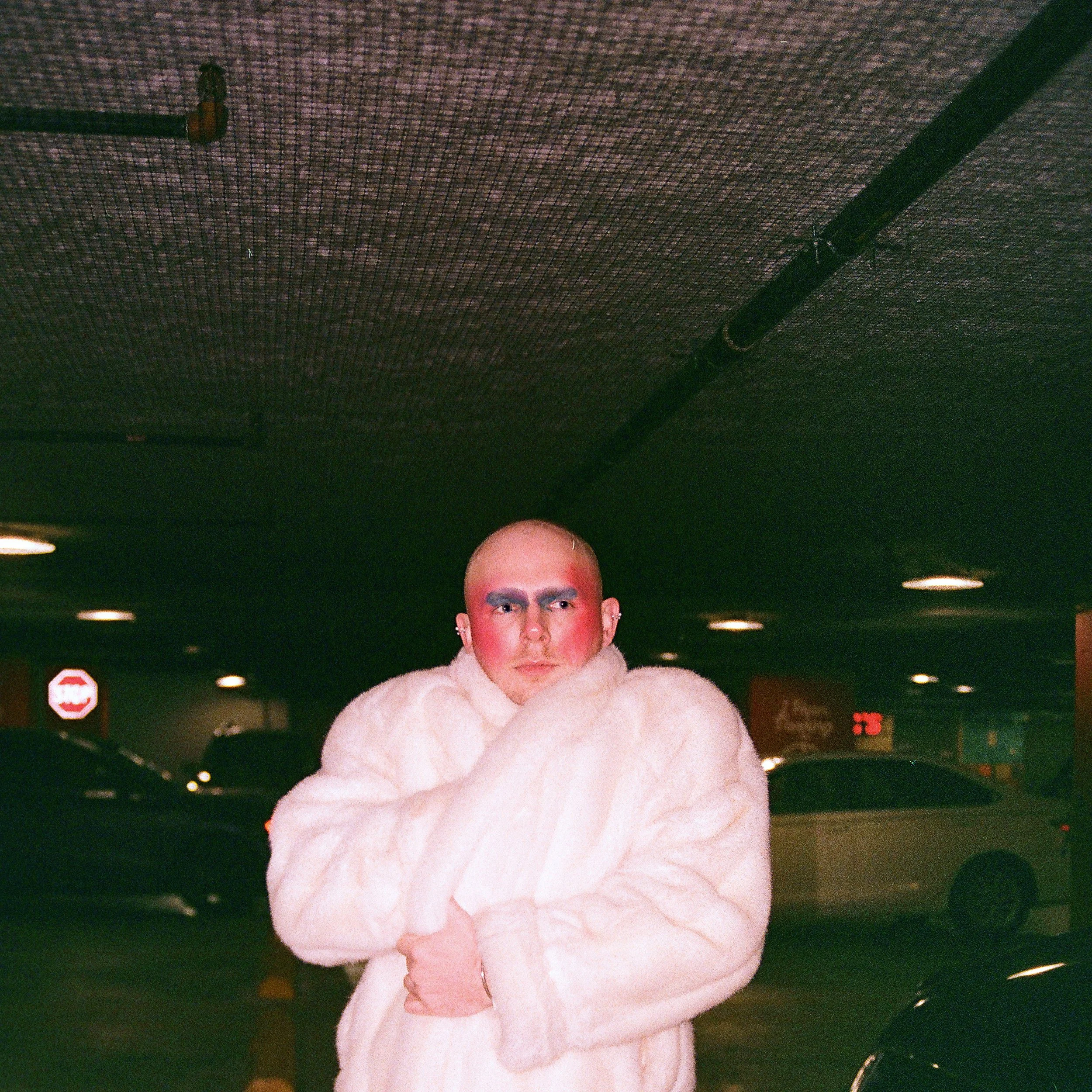 Image of a bald gay man with make up on and a fur coat in New York City shot on film