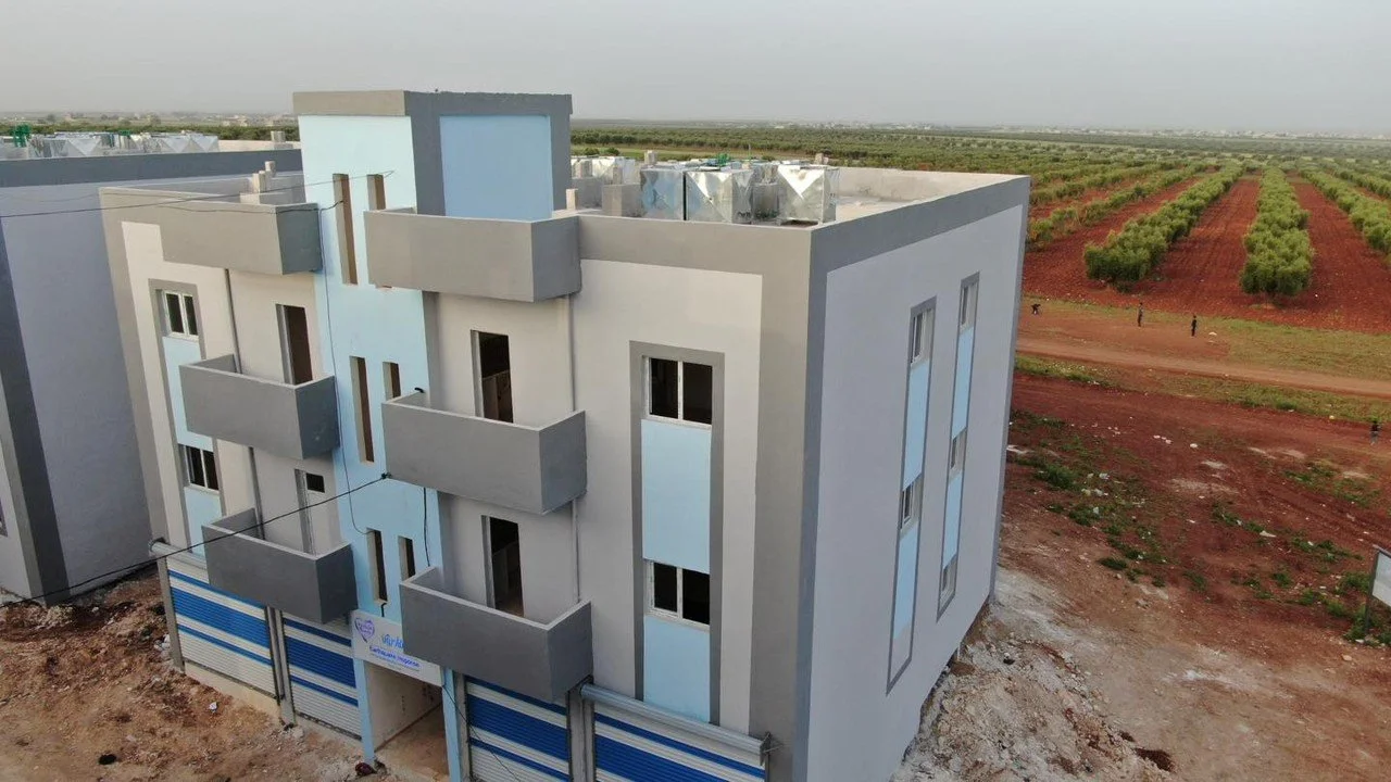 In 2014, Syrian Hands & Japan Islamic Trust completed a 3-story residential building with 12 apartments, shifting immediately from emergency shelter to permanent housing.