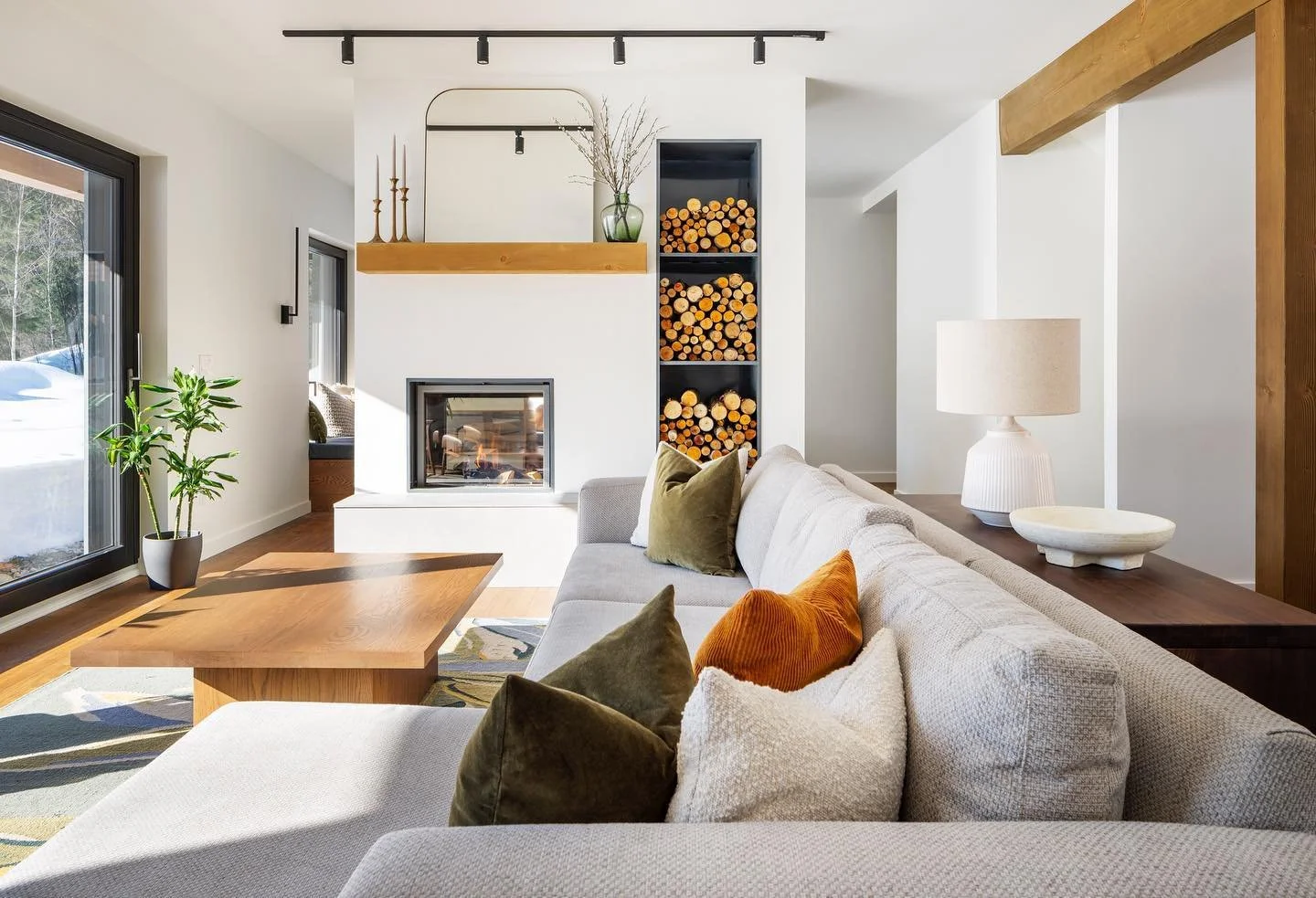 modern living room with white wall and light gray sofa really well decorated with a great afternoon lighter creating a peacefull environnement