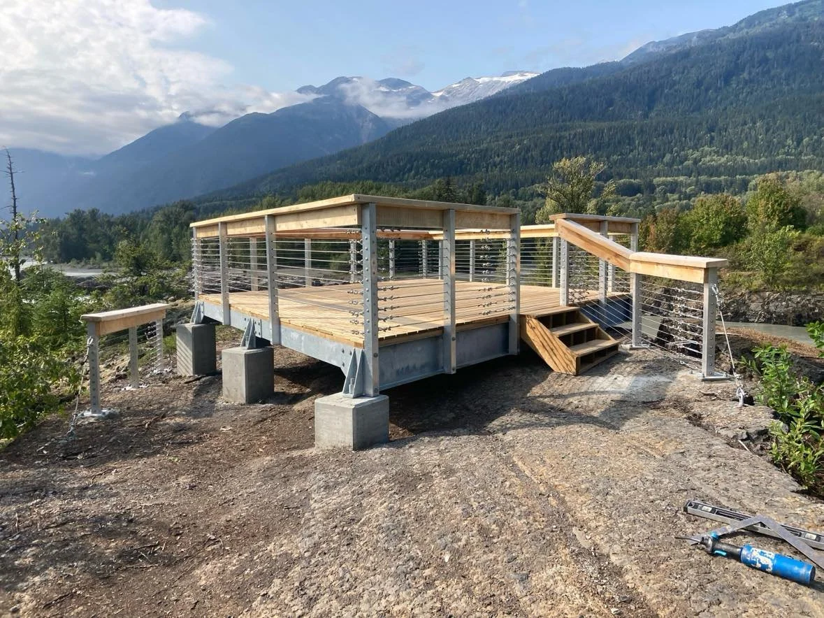 outdoor wood deck with a custom handrail built on a granite slab in Squamish