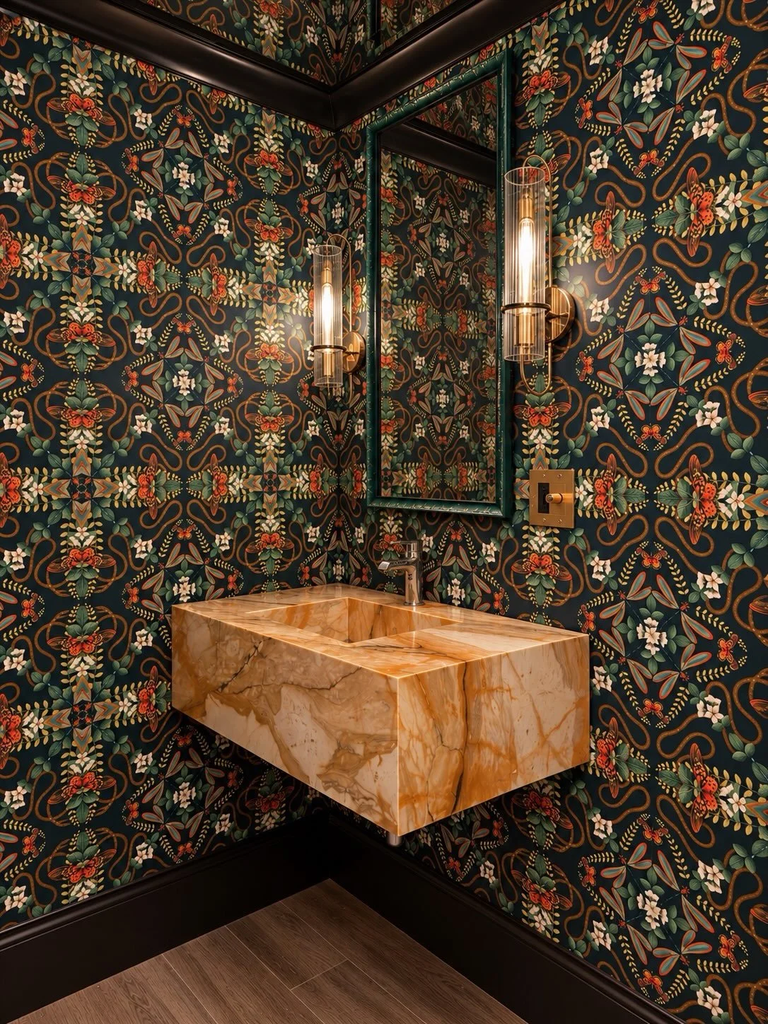 Low ceiling. High drama. 🦋🐍

Bronze mirrors overhead. A floating Giallo Siena marble vanity below. And Wedgwood gone wild on the walls. Yes, that Wedgwood. Framed monarchs and bronze snakes intertwined into hearts bring the wallpaper to life.

The 