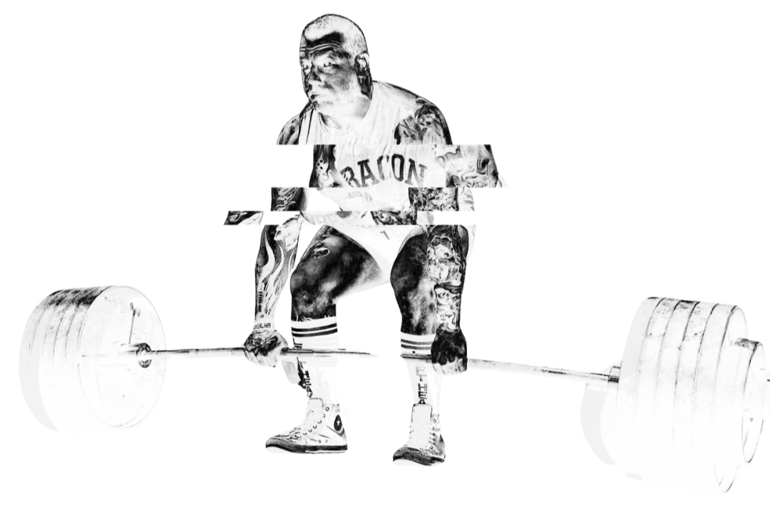 A person with tattoos lifting a barbell loaded with large weight plates, dressed in athletic clothing and sneakers.