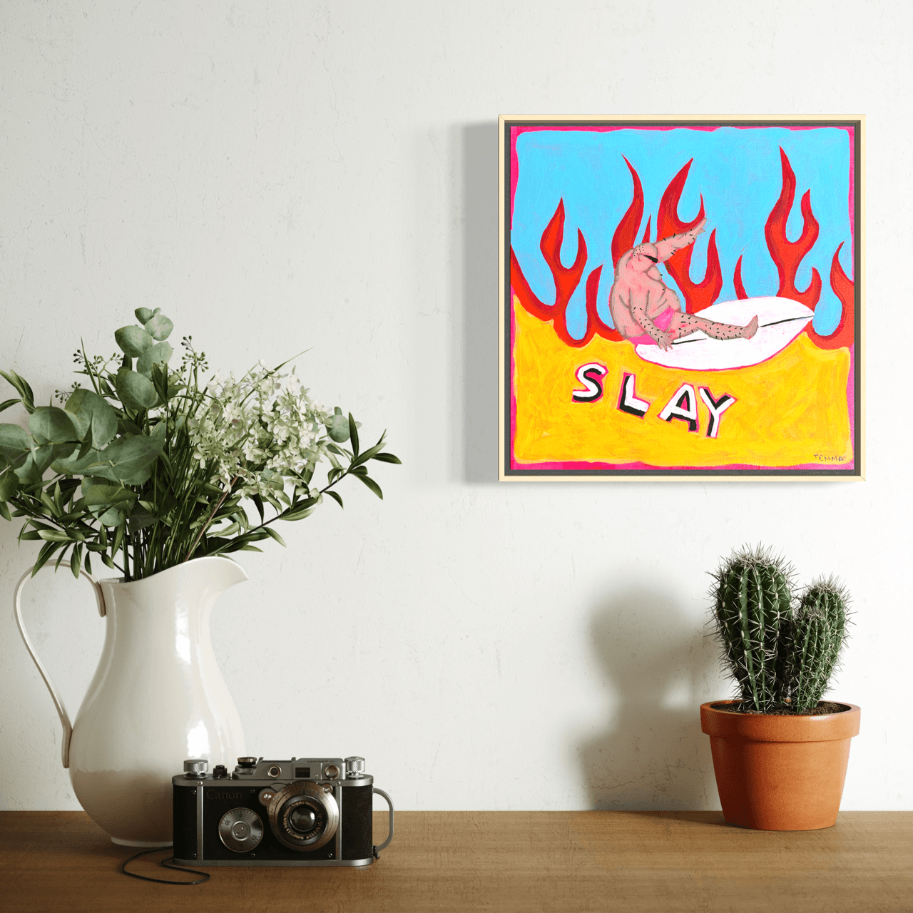 ‘Slay’ original surf painting by Temma Lee hanging on a wall, 30 x 30cm, framed in natural timber
