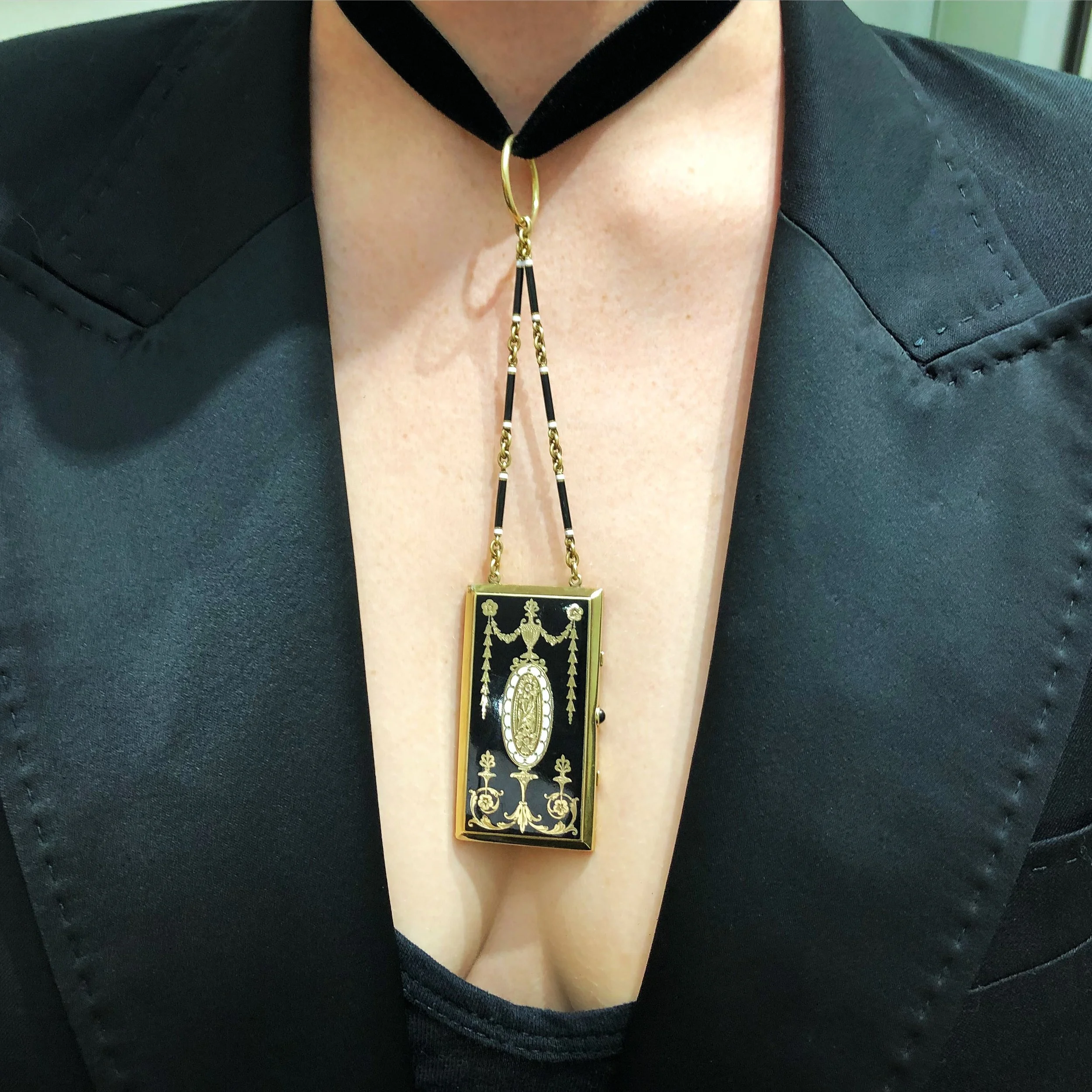 black enamel gold vanity case worn as pendant suspending from black velvet ribbon around throat